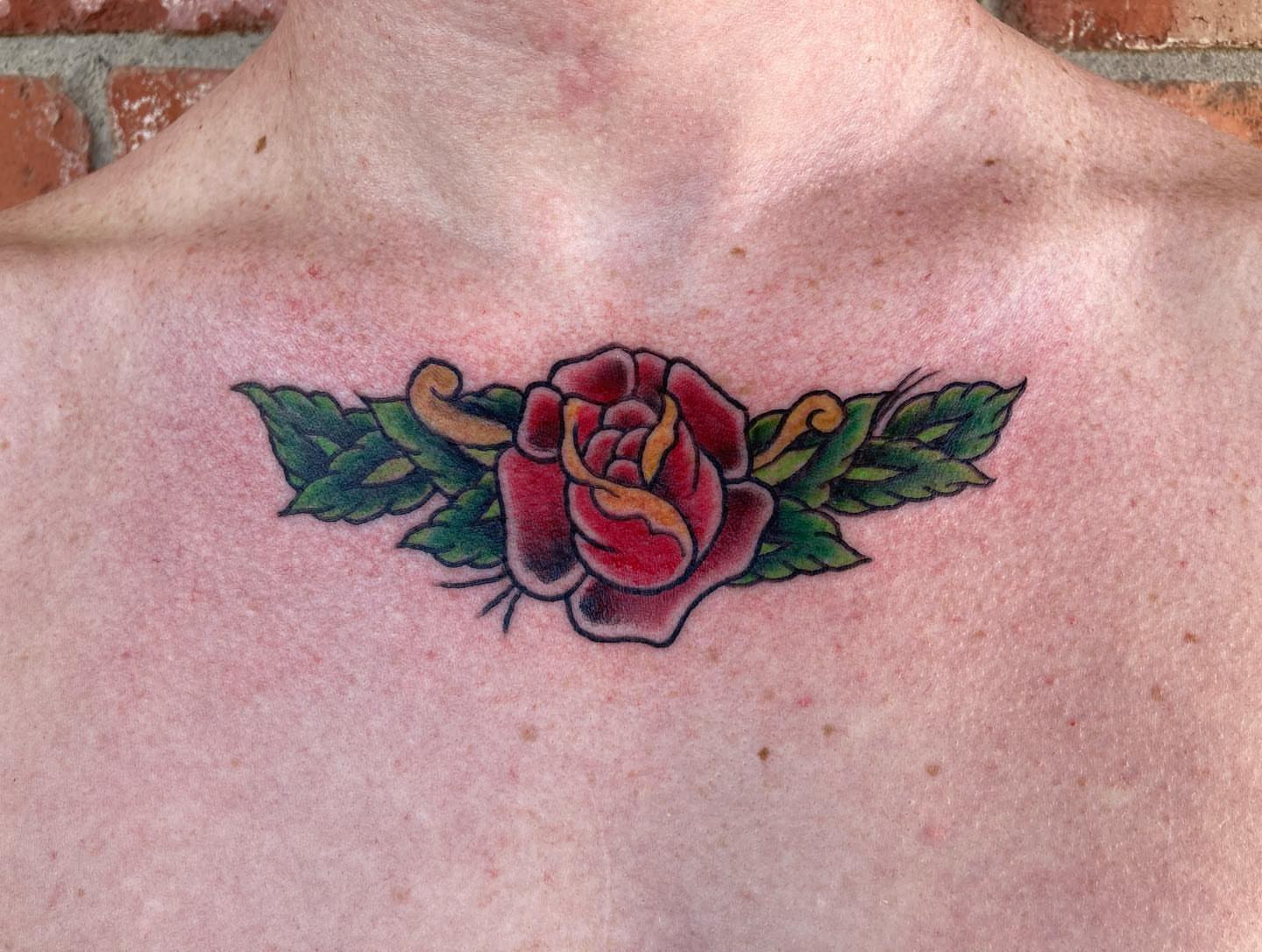 Rose American traditional tattoo on the chest by Chuck House