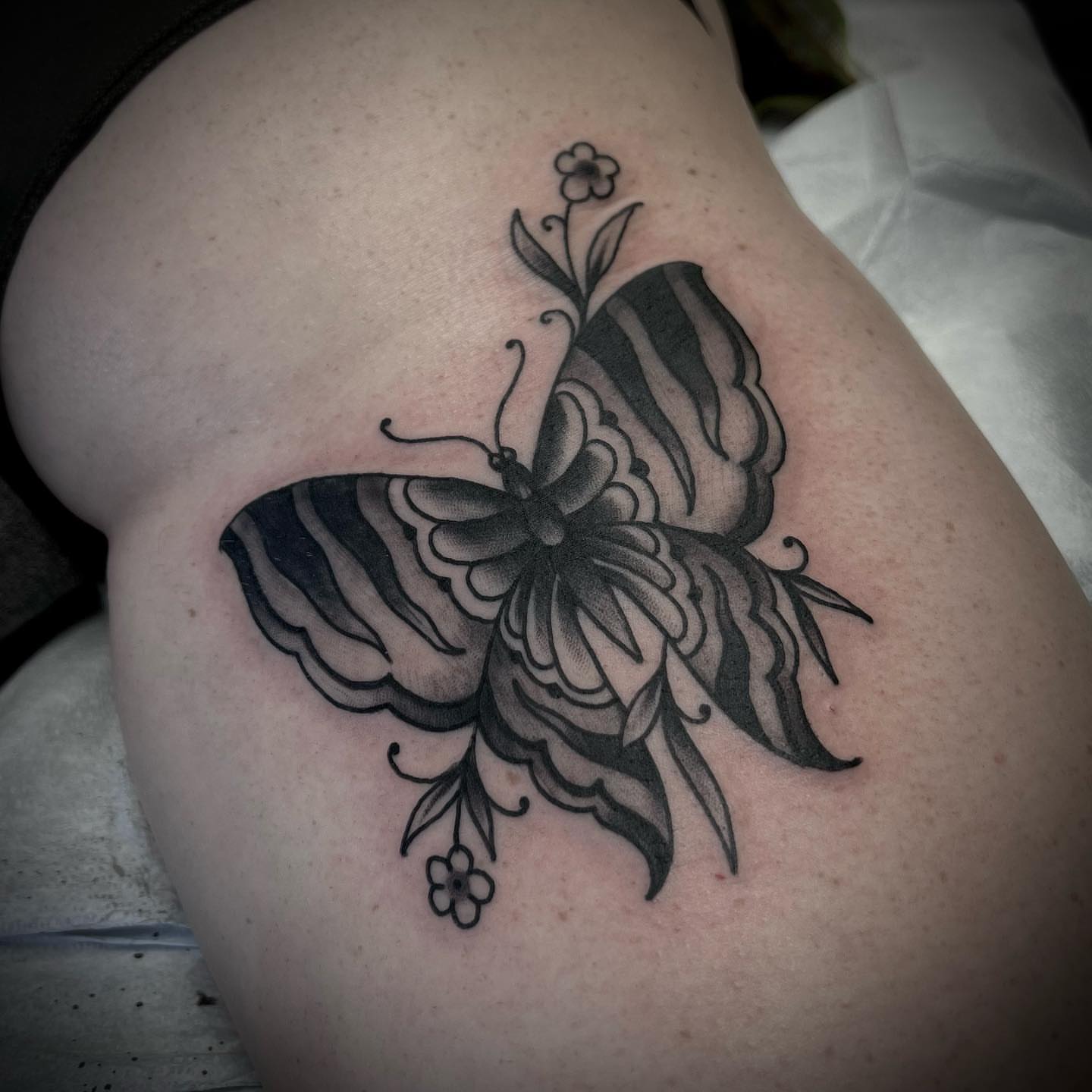 Butterfly black and grey tattoo on the thigh by Troy Mort, Altoona, Pennsylvania