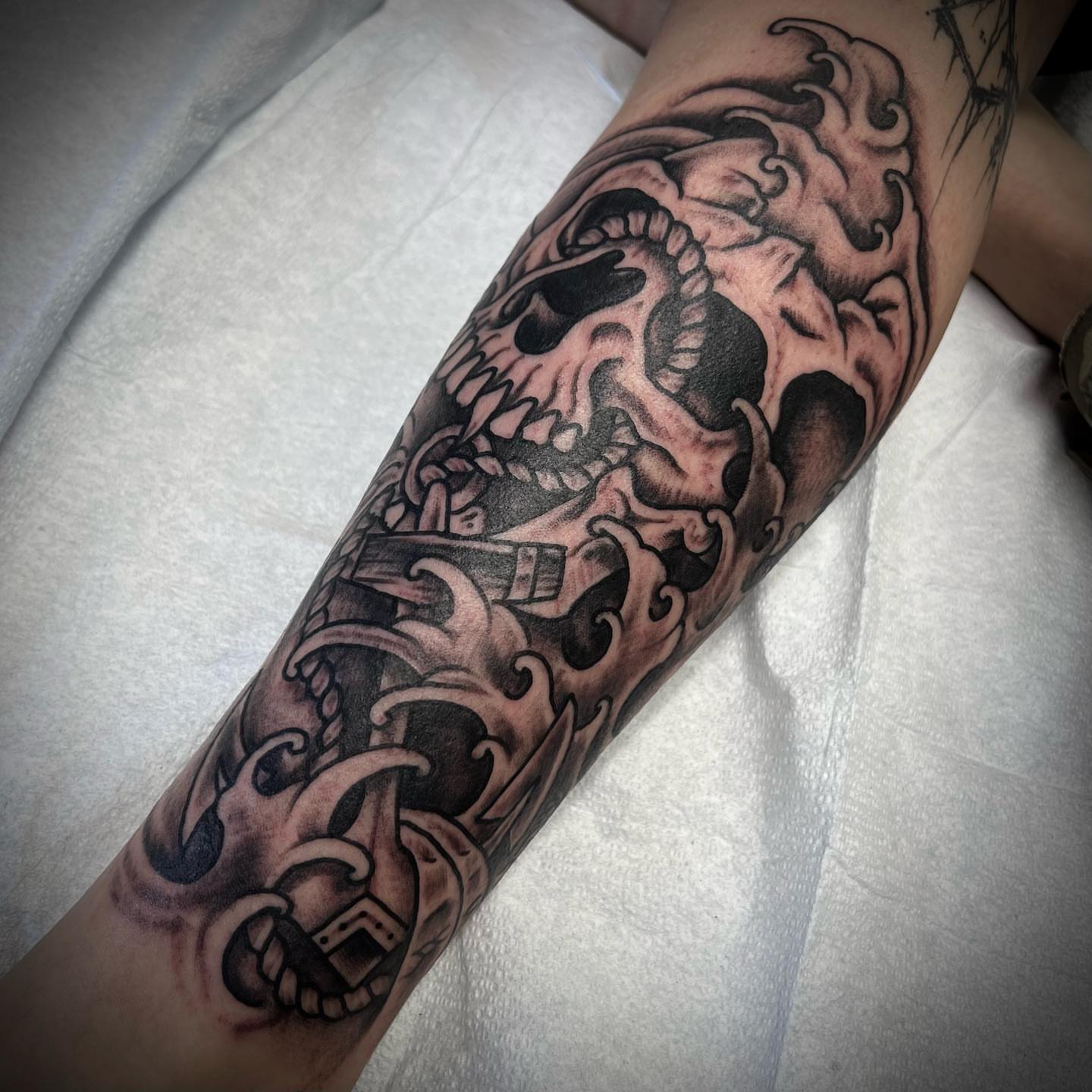 Skull and waves japanese irezumi tattoo on the forearm by Troy Mort, Altoona, Pennsylvania