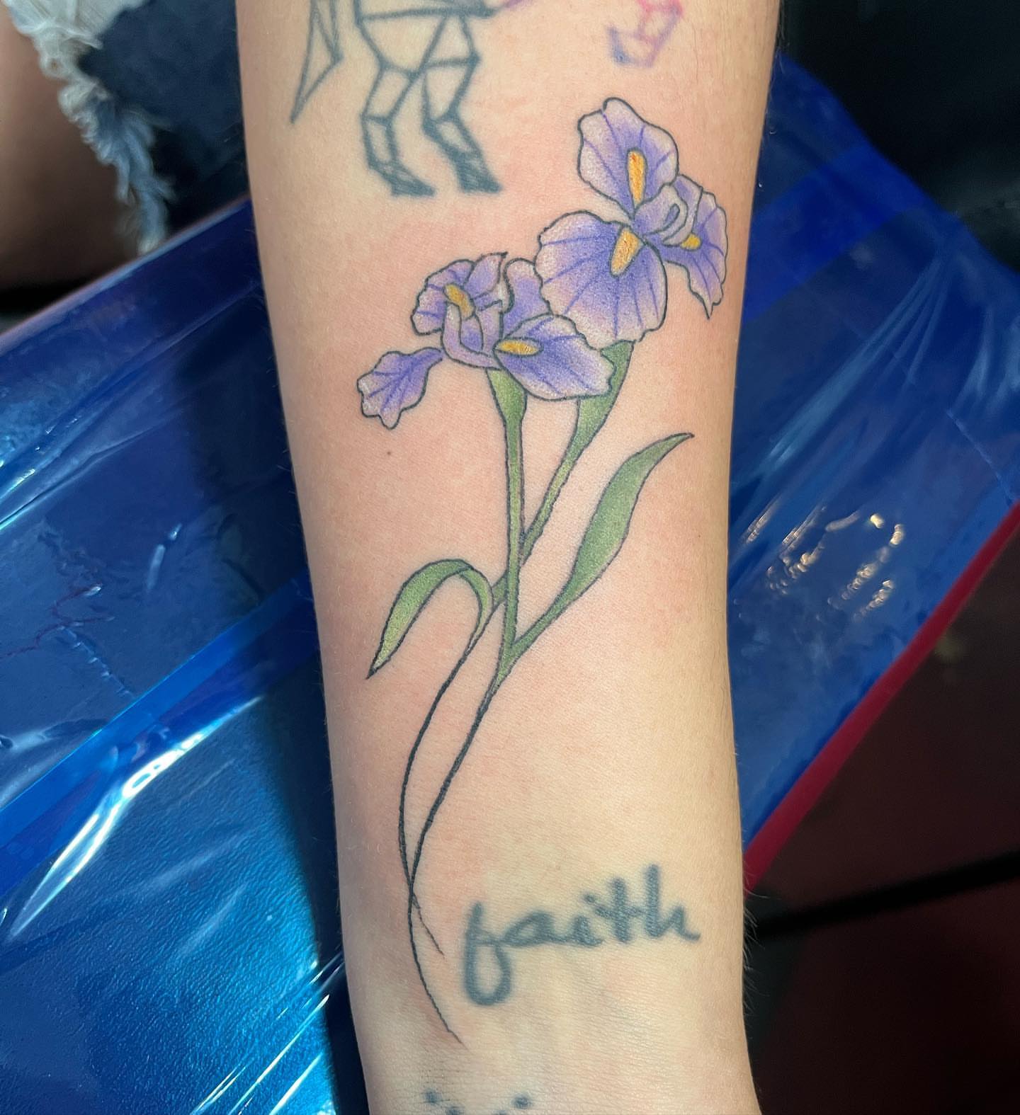 Iris flowers realism tattoo on the forearm by IdleHandsFlex, New Orleans, Louisiana
