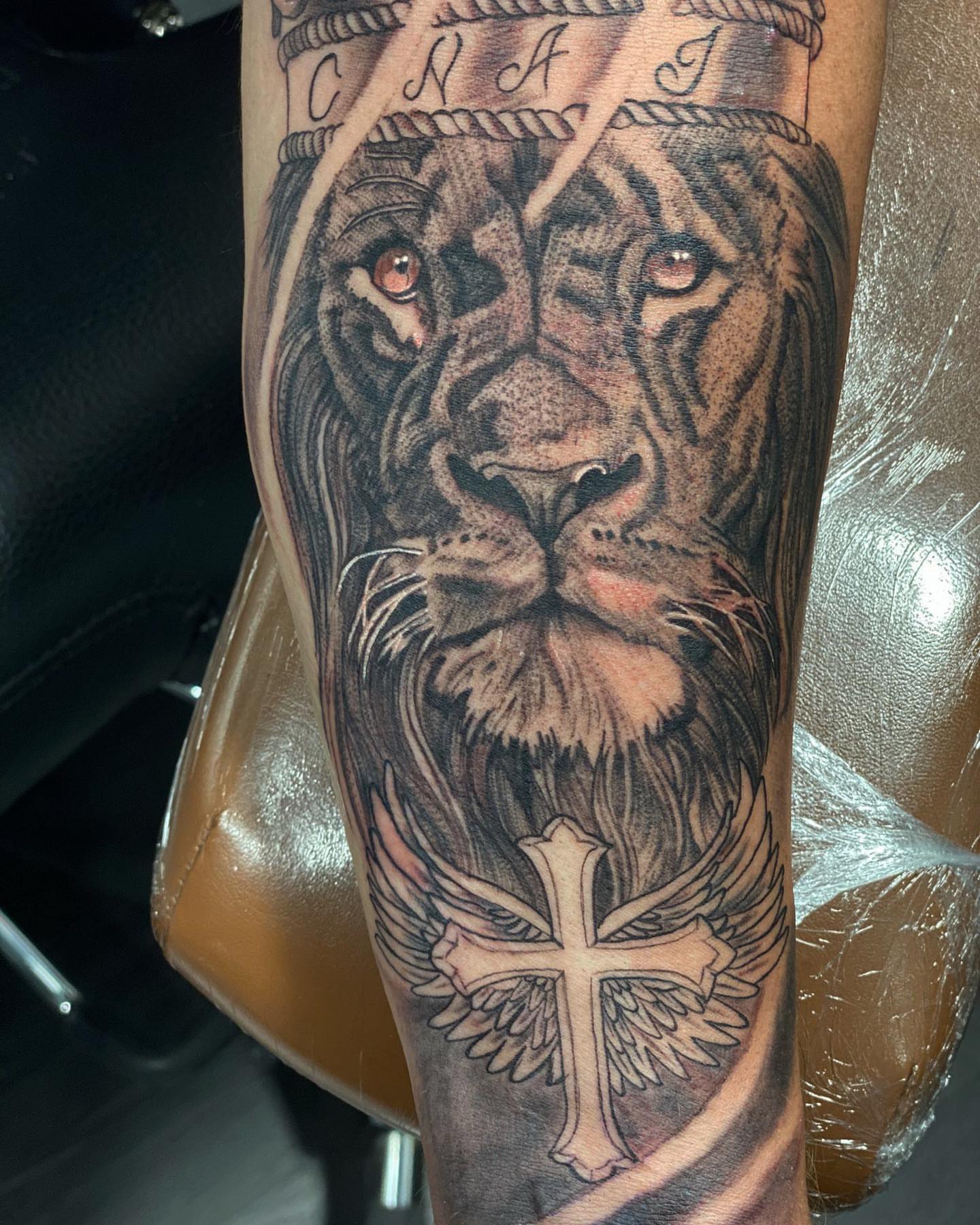 Lion with crown realism tattoo on the forearm by Alberto Ramirez