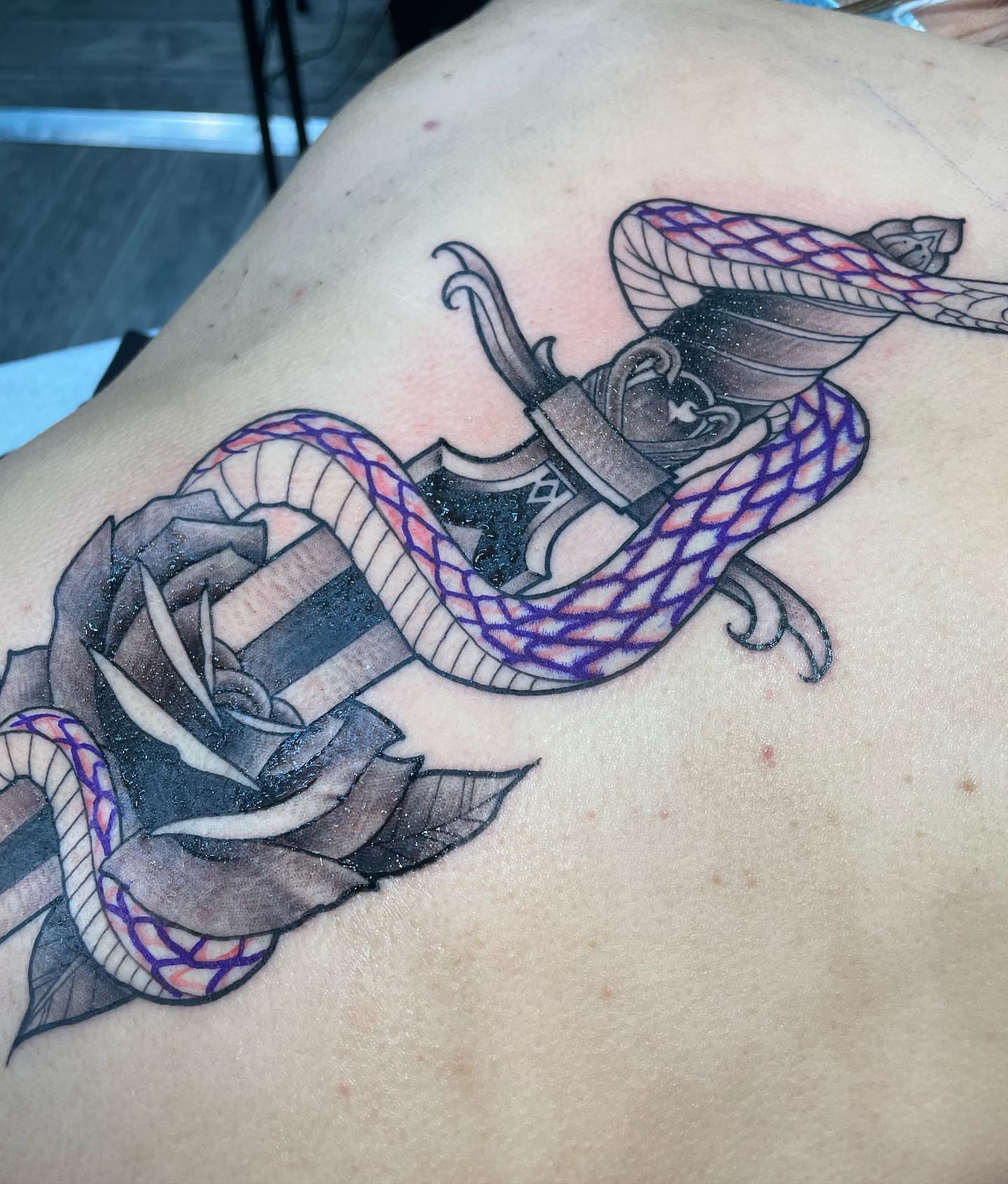 Snake and rose American traditional tattoo on the back by Yari, Los Angeles, California