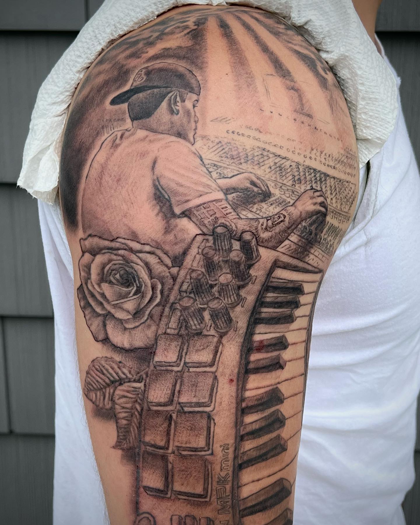 Keyboard player realism tattoo on the upper arm by Iconic Ink, Millbury, Massachusetts