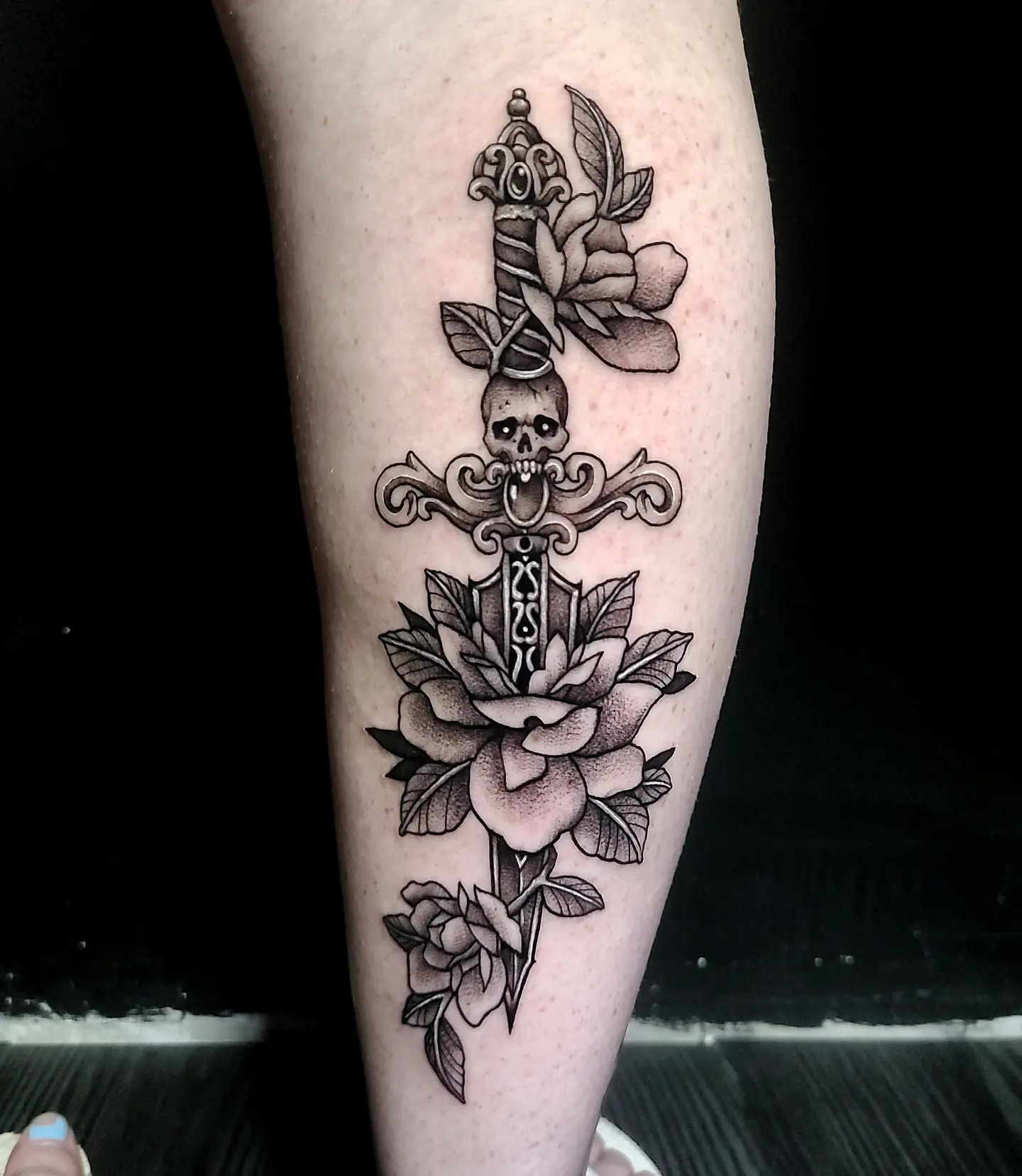 Sword and roses dotwork tattoo on the forearm by Sydney Paige, Mentor, Ohio