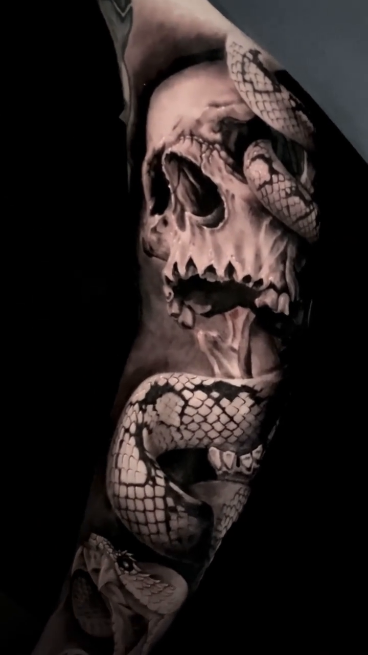 Skull and snakes realism tattoo by Sean Flood