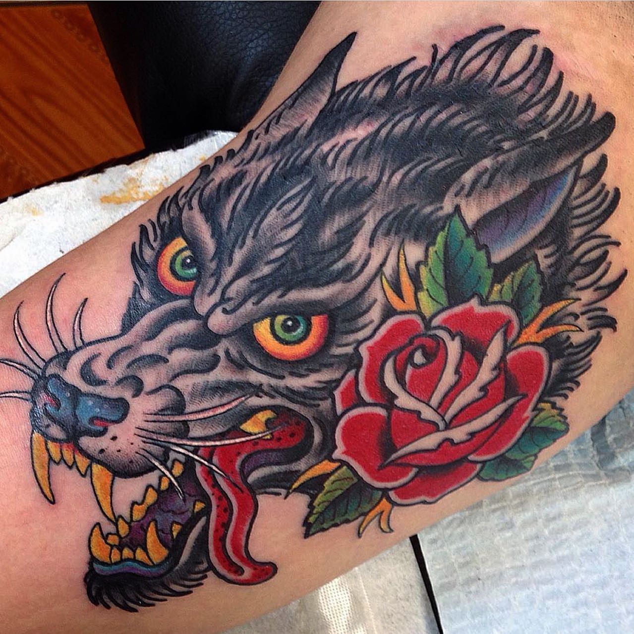 Wolf and rose American traditional tattoo on the forearm by Bryan Humphries