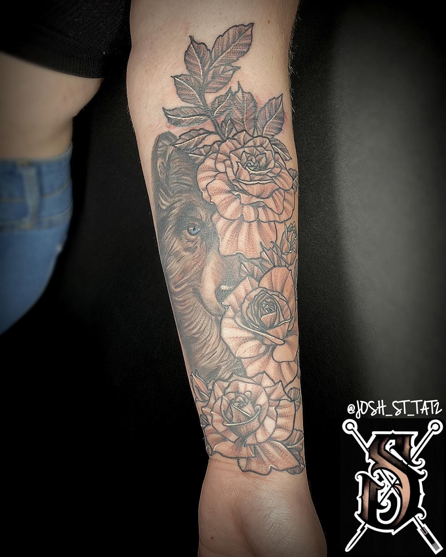Lion and roses realism tattoo on the forearm by Josh St.germain