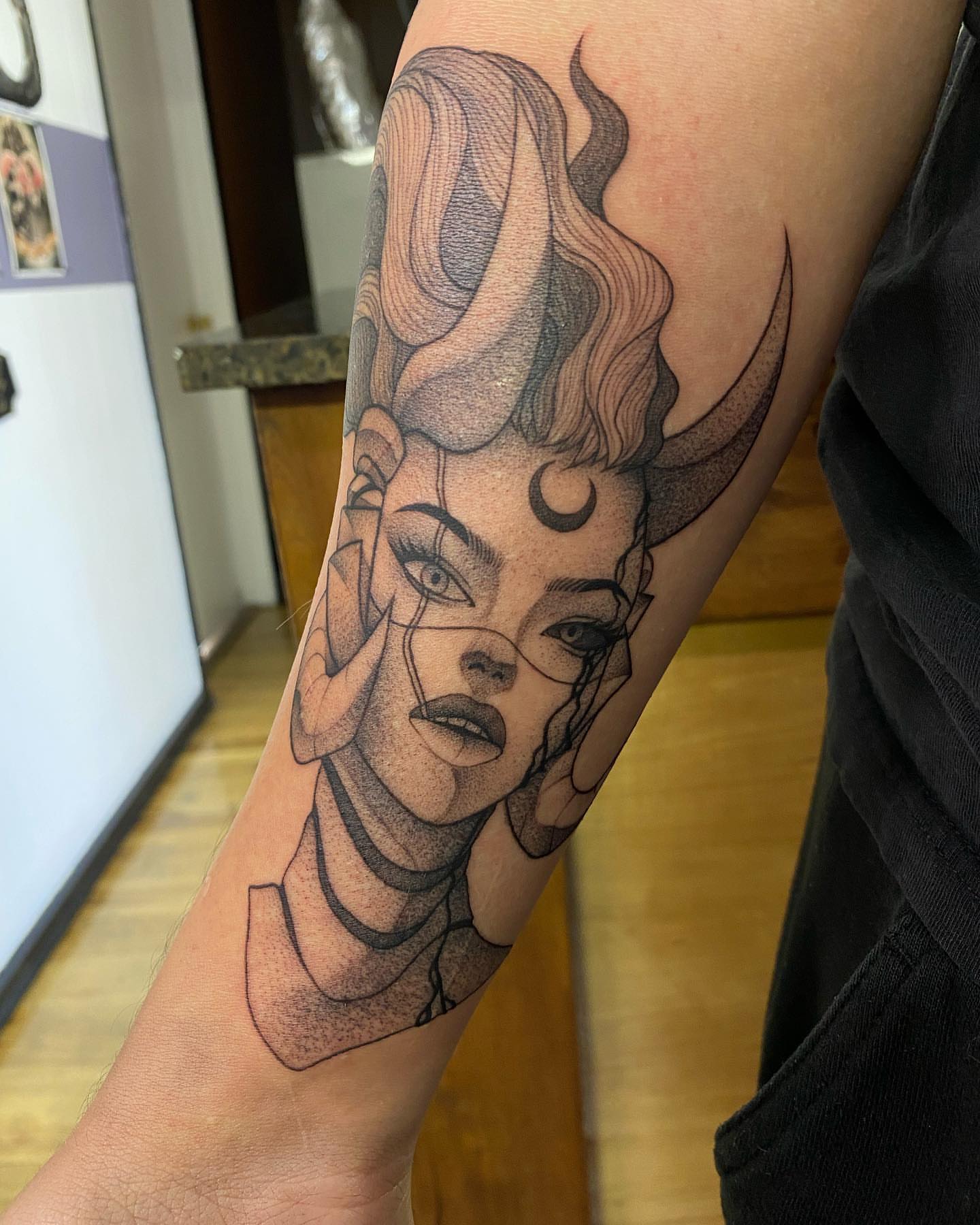 Woman with horns dotwork tattoo on the forearm by seattle tattoo artist