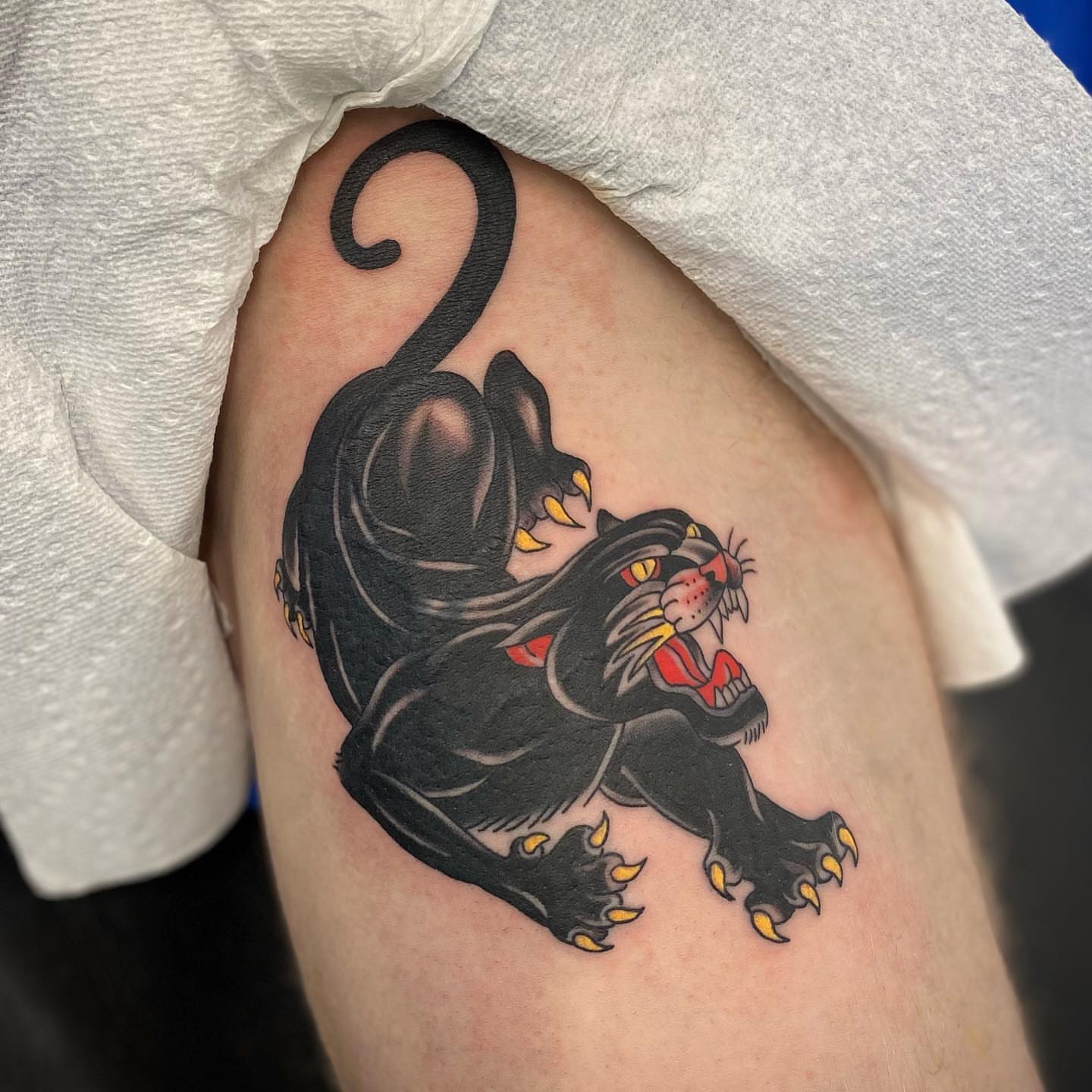 Panther American traditional tattoo on the thigh by Christopher McGlone