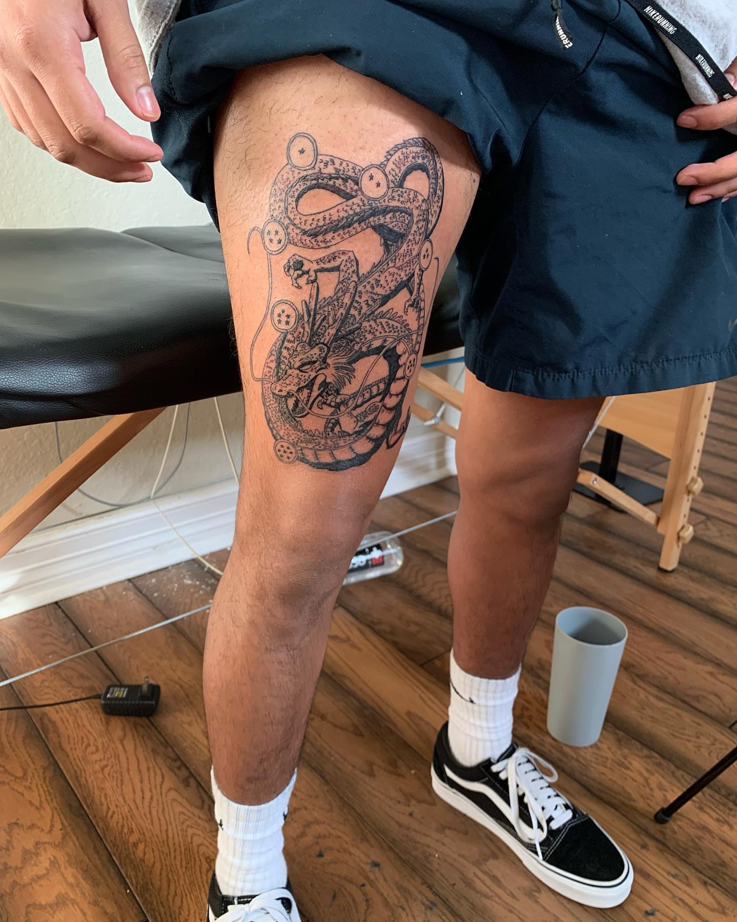 Snake black and grey tattoo on the thigh by Leo Torres