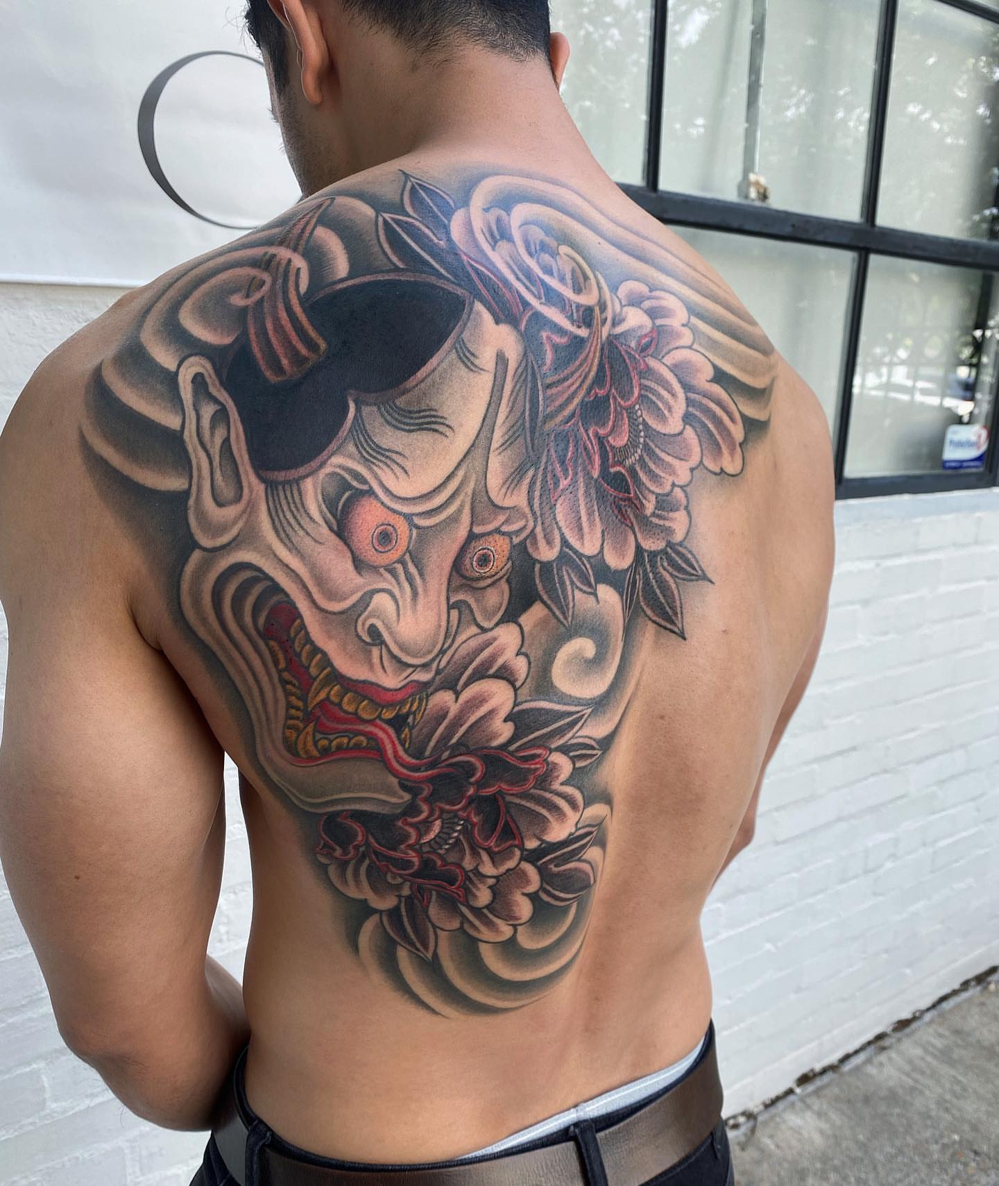 Demon mask and flowers japanese irezumi tattoo on the back by H O R I H A N