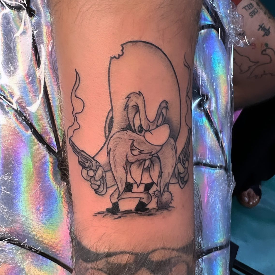 Donald duck black and grey tattoo on the forearm by Syd Cheyenne