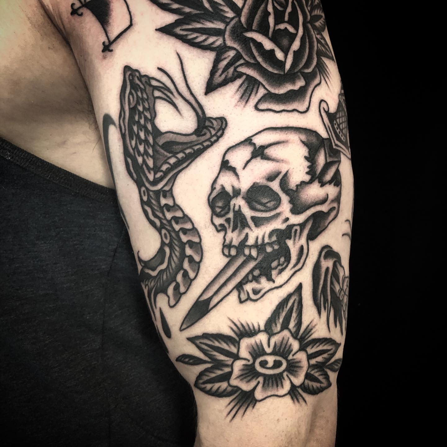 Skull and snake American traditional tattoo on the forearm by Sean McMahon