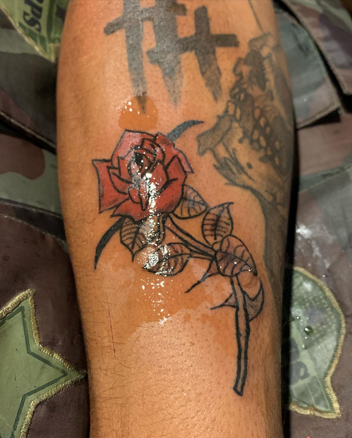 Red rose American traditional tattoo on the forearm by El Zepa