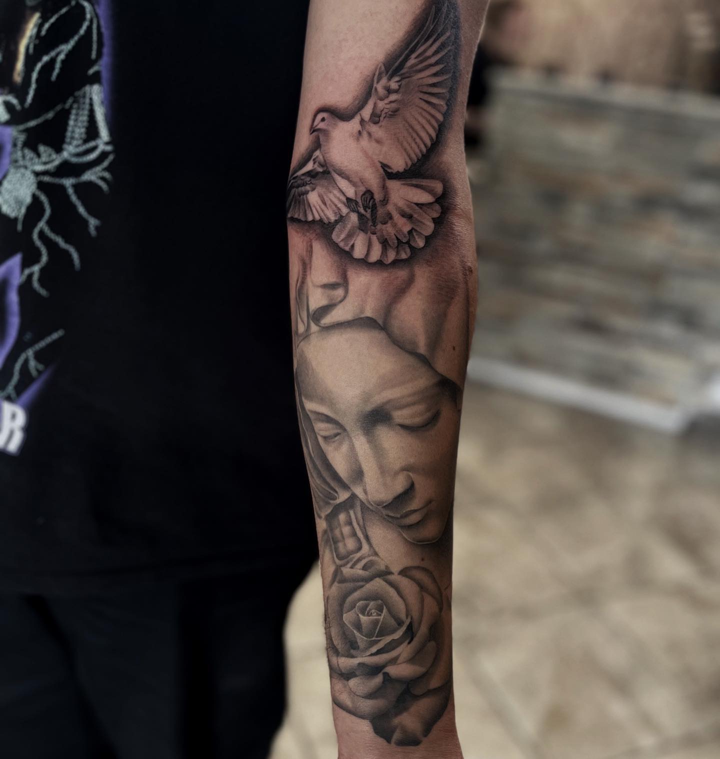 Woman with dove and rose realism tattoo on the forearm by Aaron Carey, Salem, Oregon