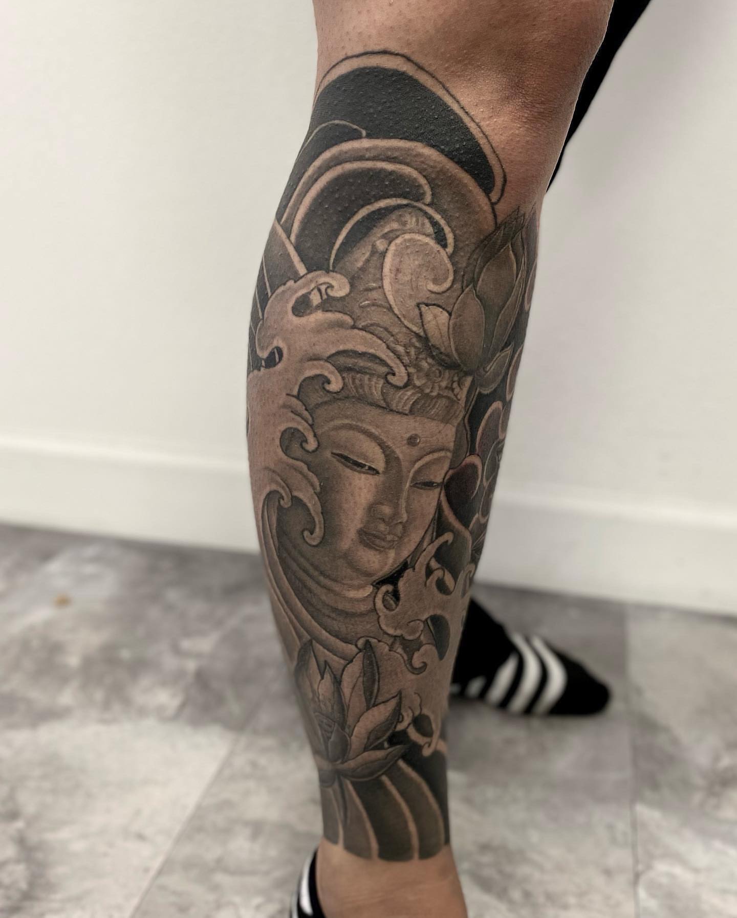Buddha head with lotus japanese irezumi tattoo on the calf by Daniel Gutierrez