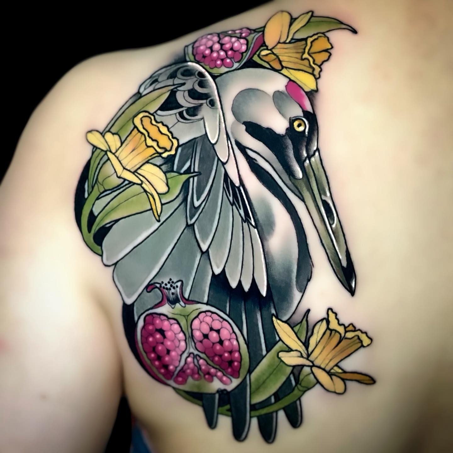 Pelican and flowers American traditional tattoo on the shoulder by Nathan Mickle