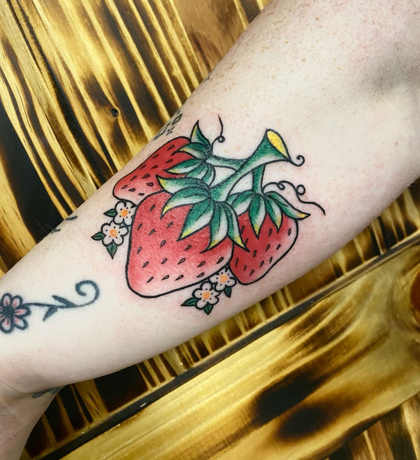 Strawberries and flowers American traditional tattoo on the forearm by ππππππ ππππππ