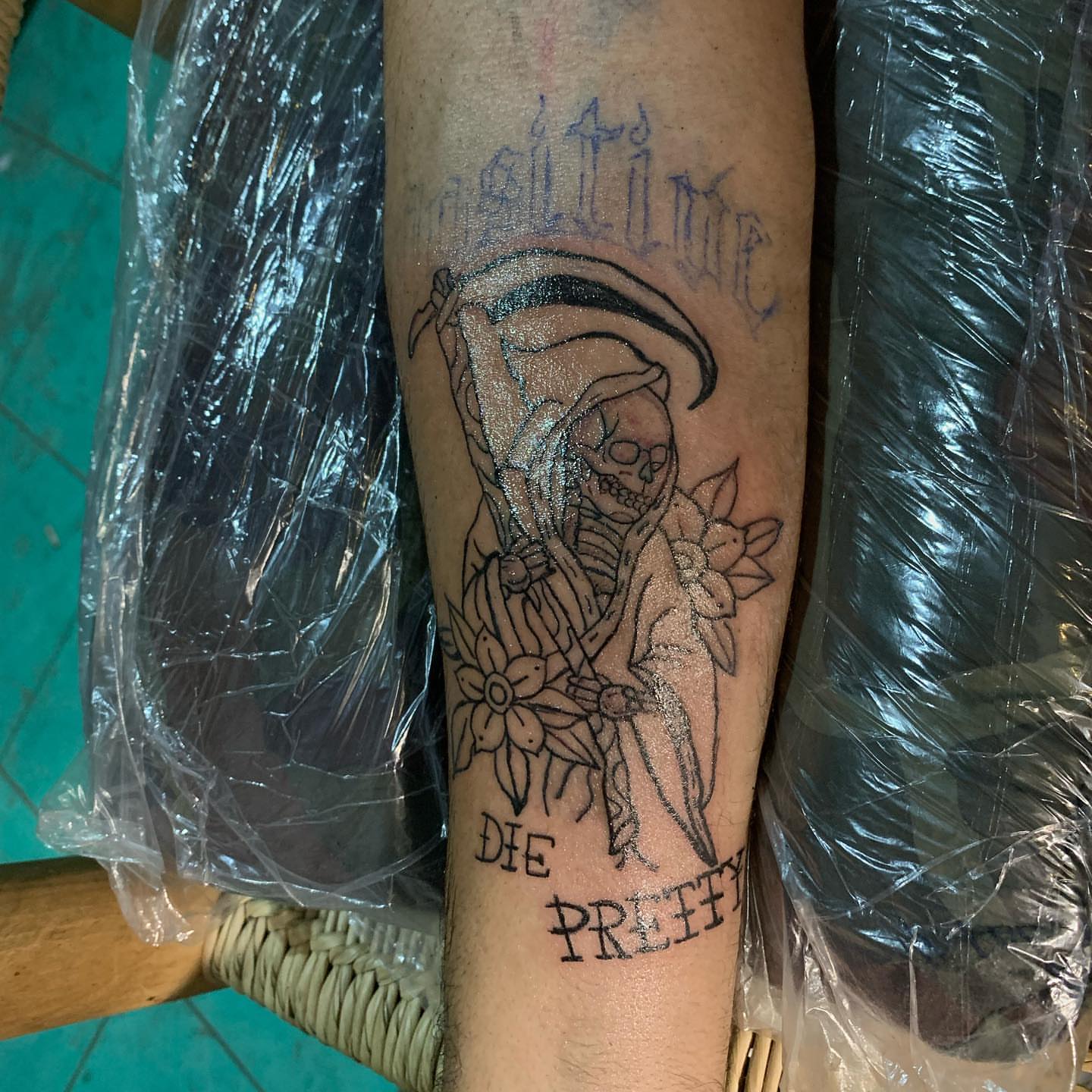Grim reaper with flowers black and grey tattoo on the forearm by El Zepa