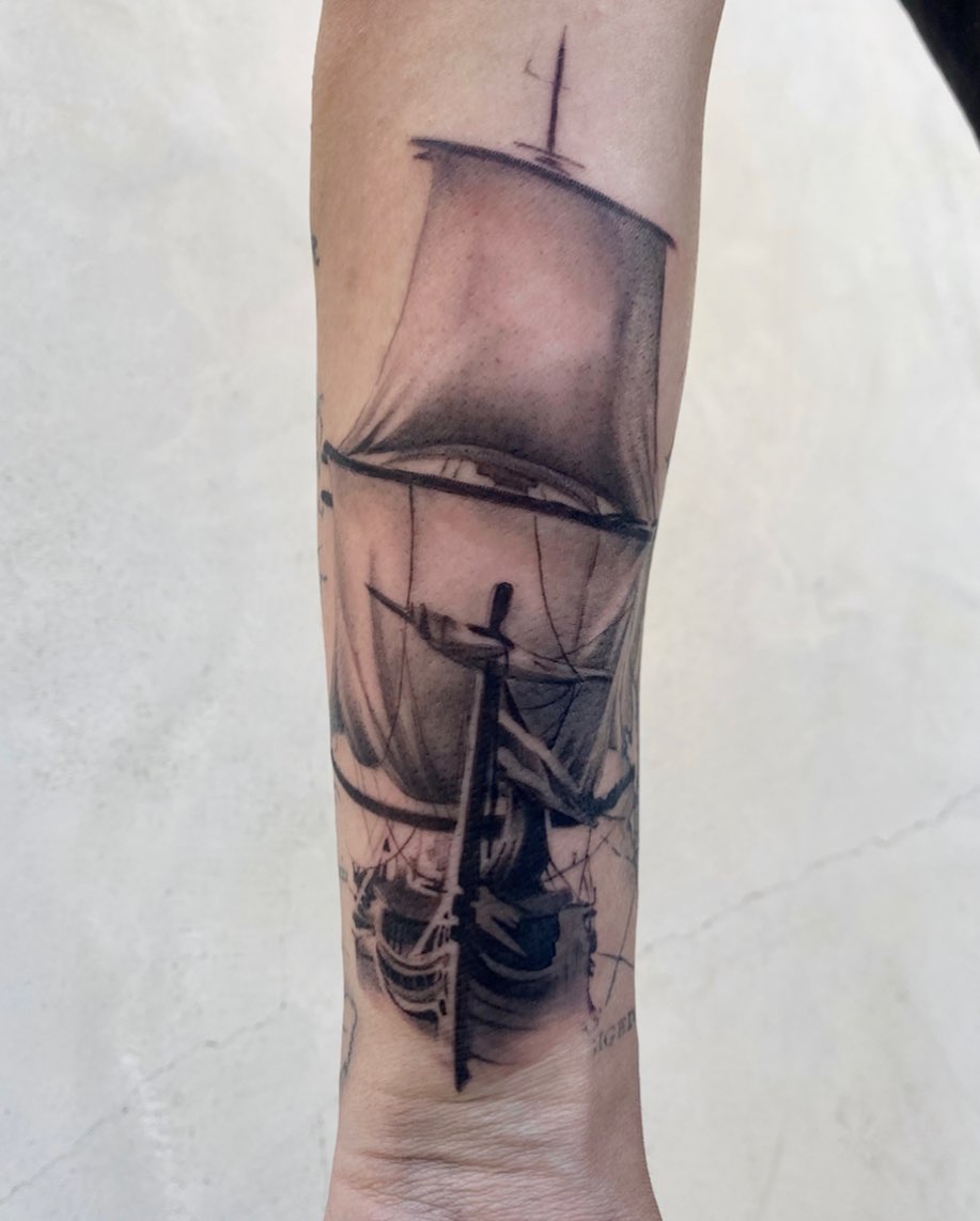 Sailboat black and grey tattoo on the forearm by Oxana