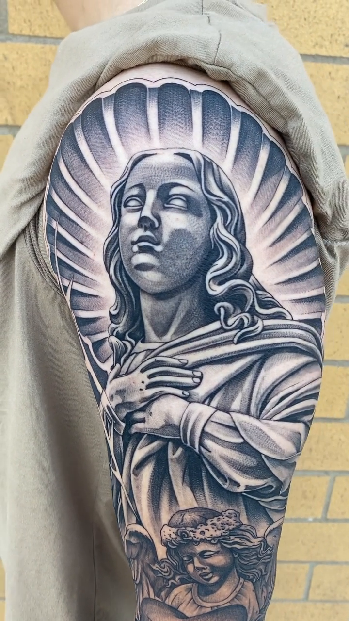 Religious figure with cherubs realism tattoo by Kyle Lopez, Union City, California