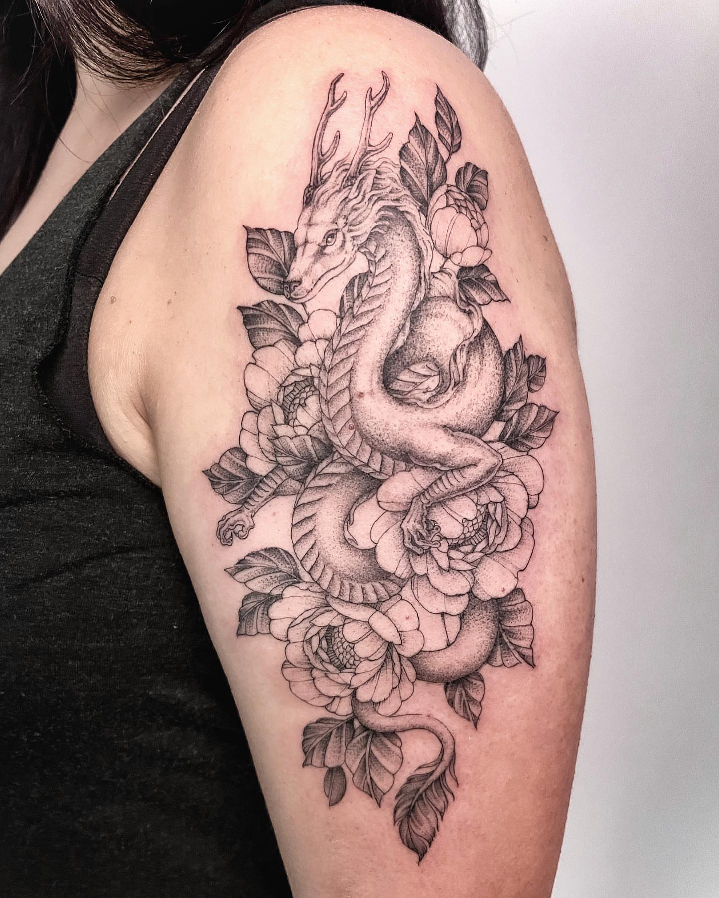 Dragon and flowers dotwork tattoo on the shoulder by Michigan Tattoo Artist