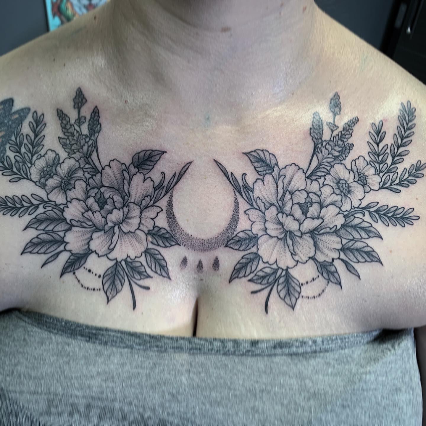 Floral crescent moon dotwork tattoo on the chest by TyEsha Reels