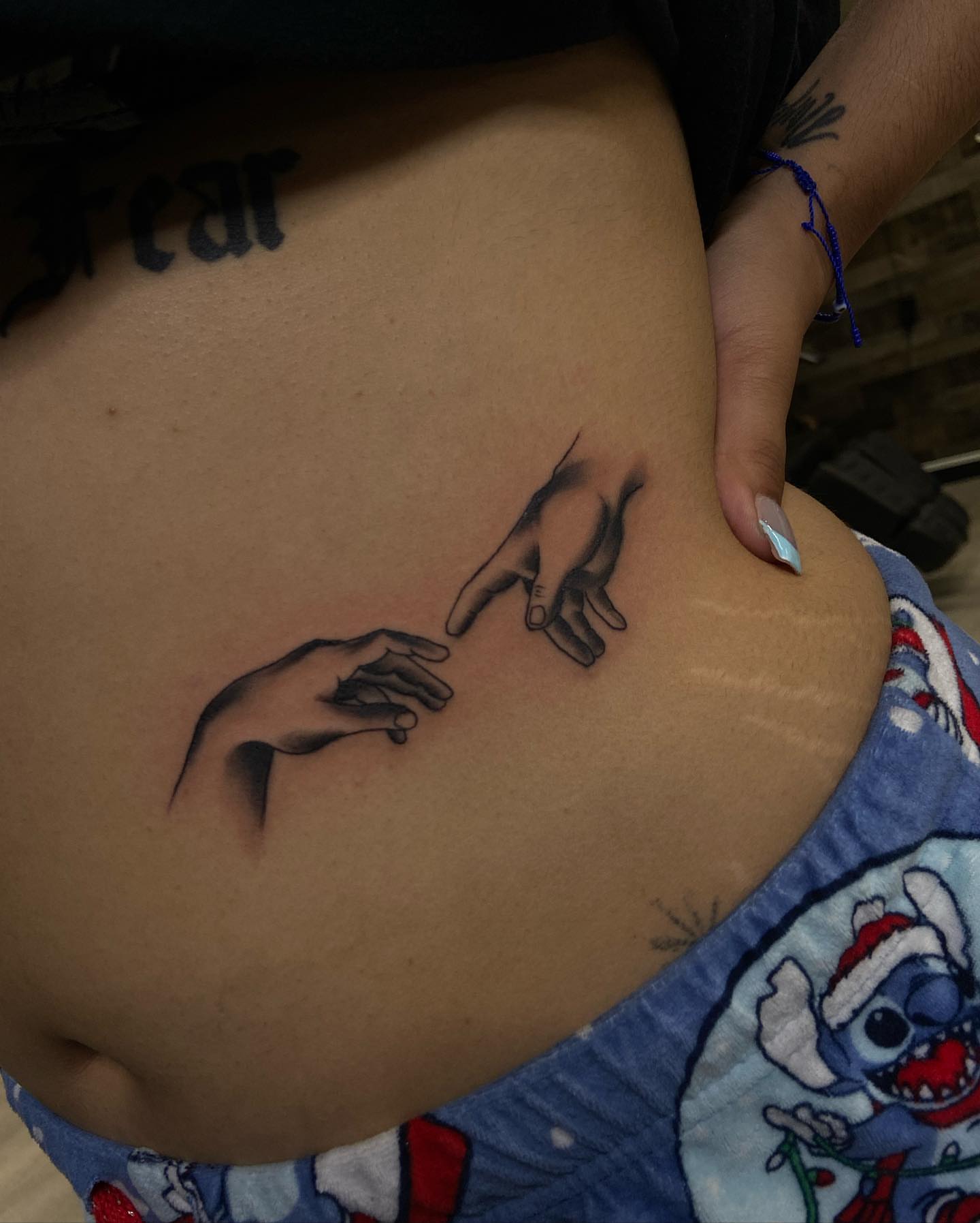 Hands reaching black and grey tattoo by Moose