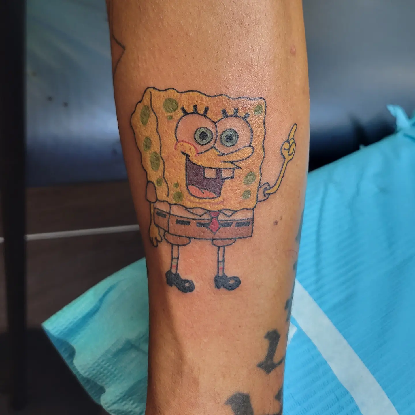 SpongeBob SquarePants new school tattoo on the forearm by Nicole Bett