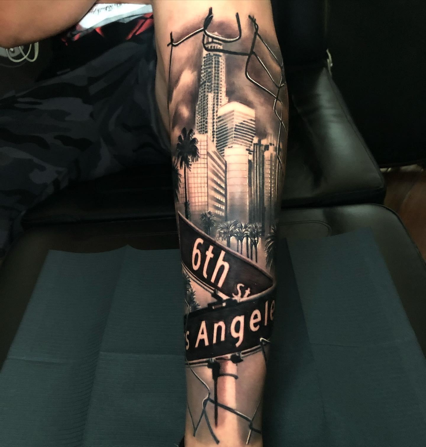 Cityscape realism tattoo on the forearm by Michael Martinez