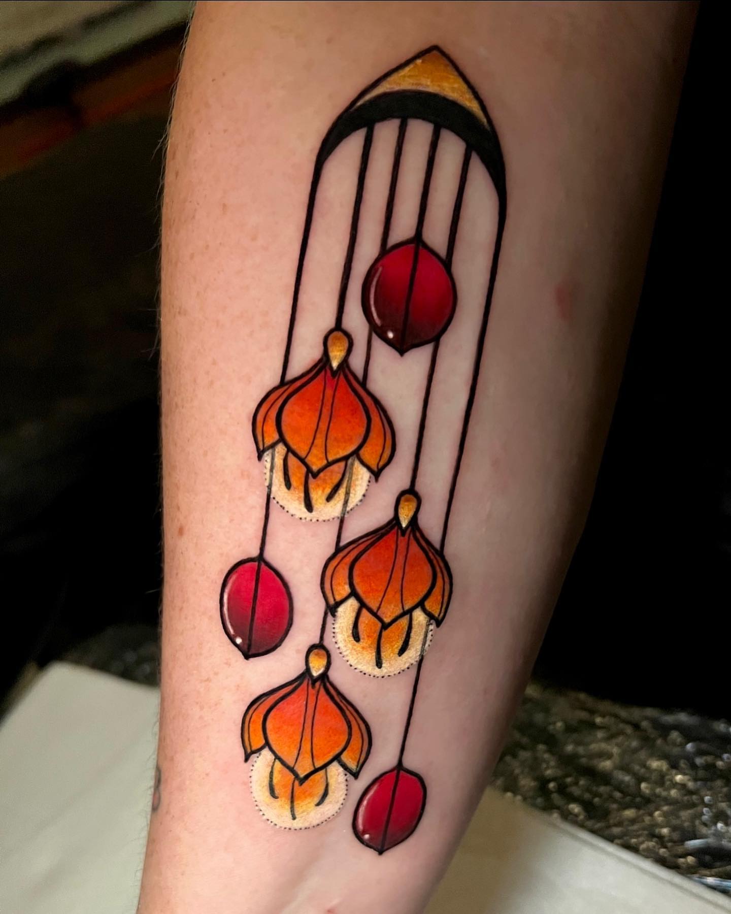 Wind chime geometric tattoo on the forearm by Cortney Norton