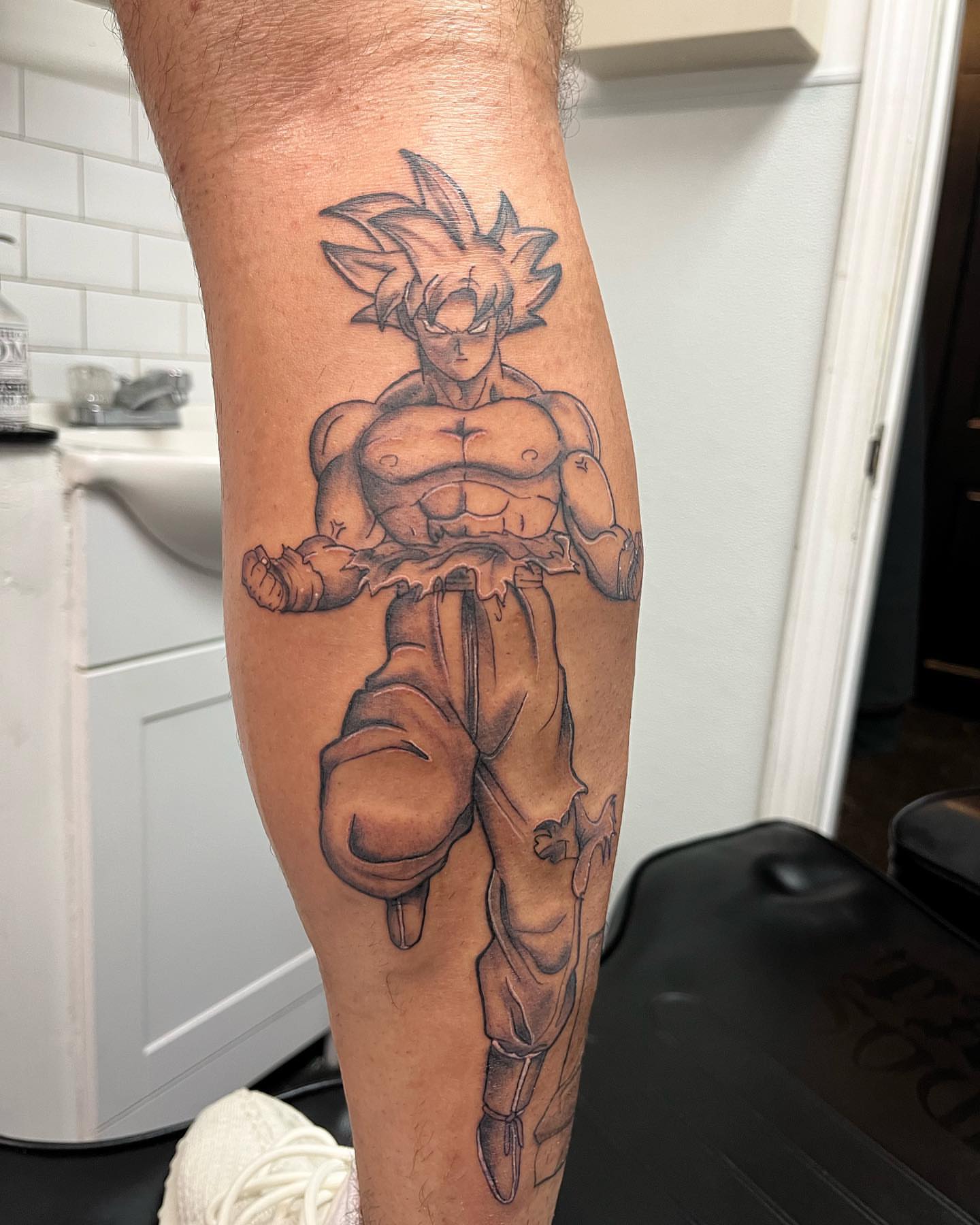 Son goku anime tattoo on the forearm by Edward A. Boesch