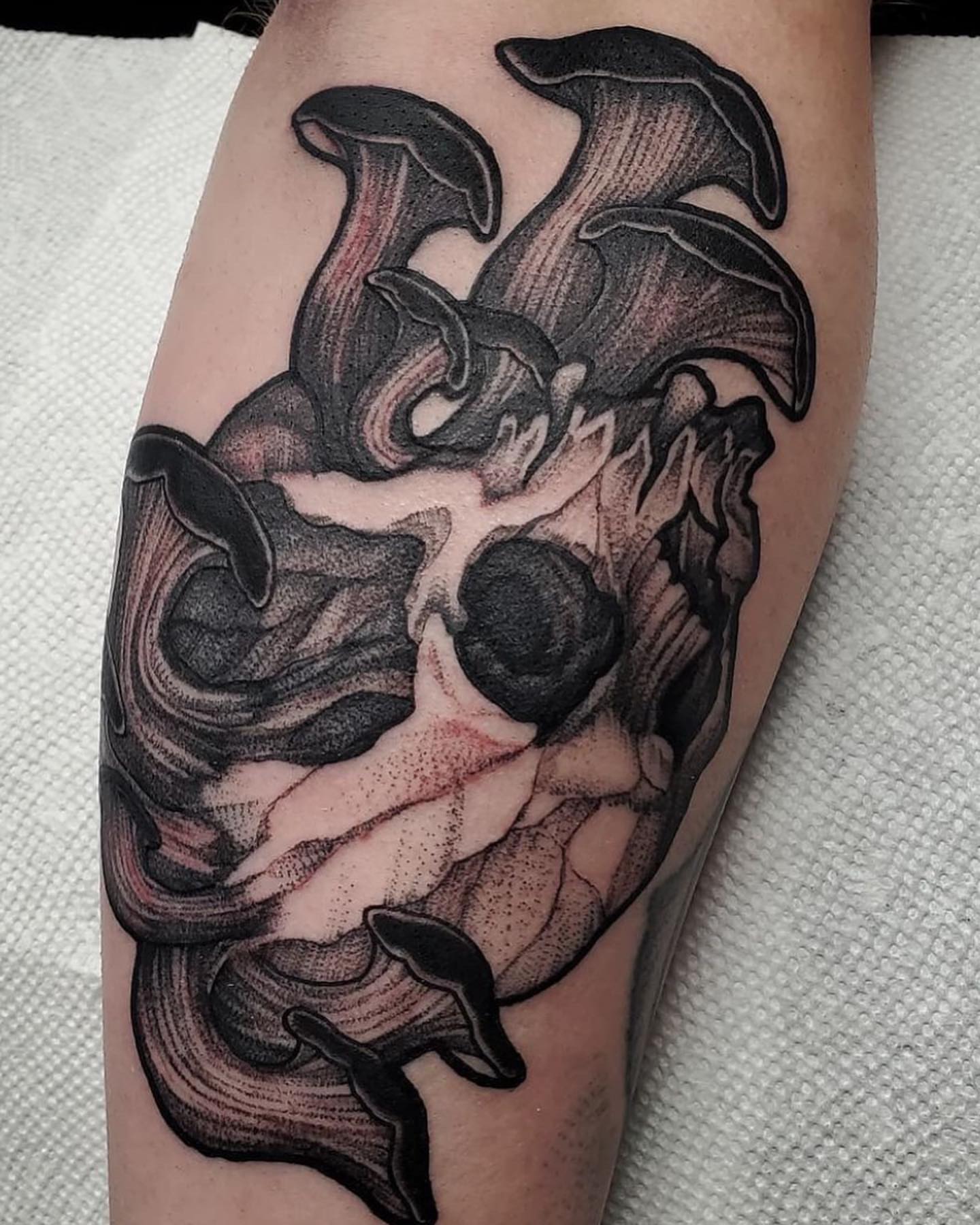 Abstract flame dotwork tattoo on the forearm by Kyle Black