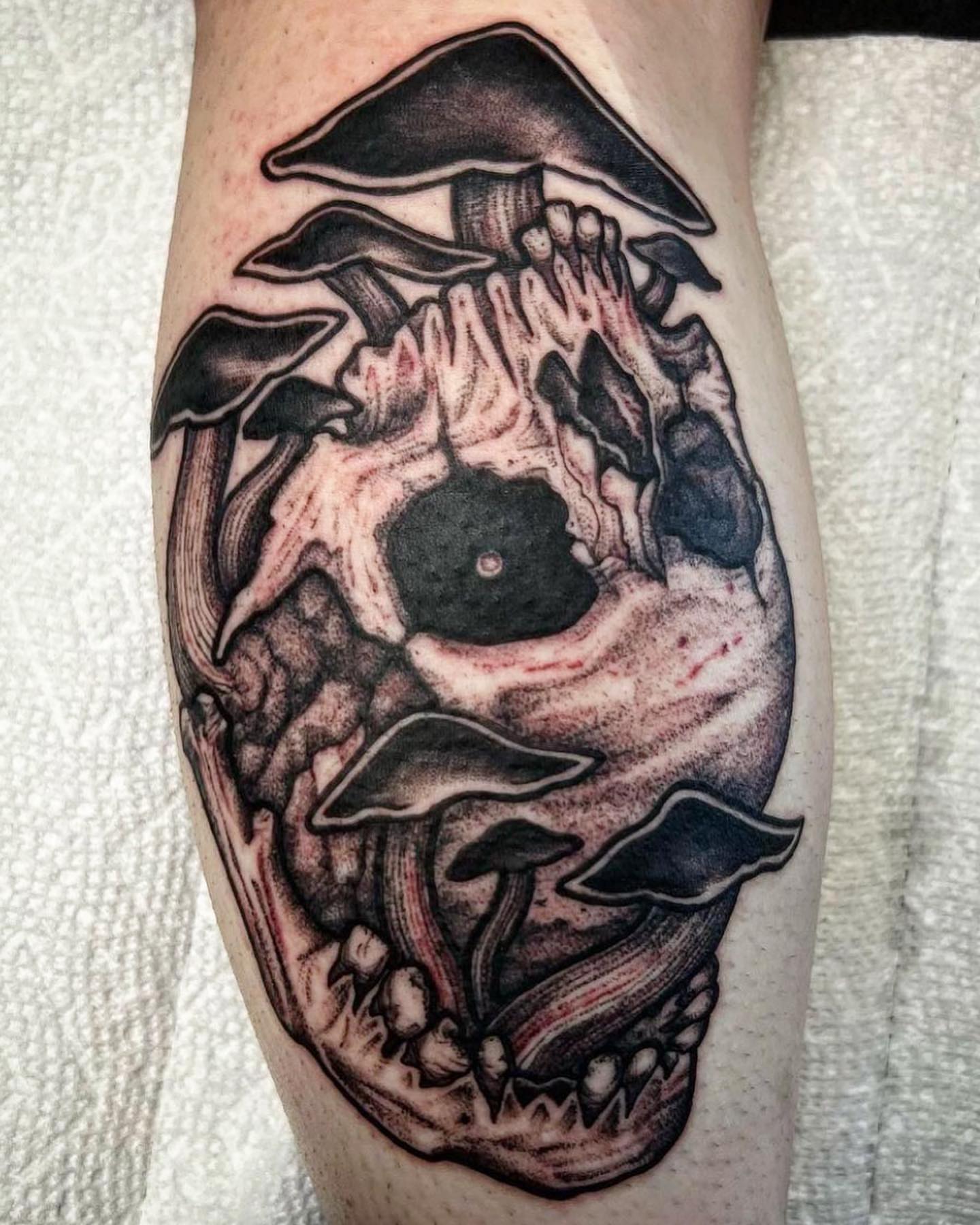 Mushroom skull dark realism tattoo on the forearm by Kyle Black