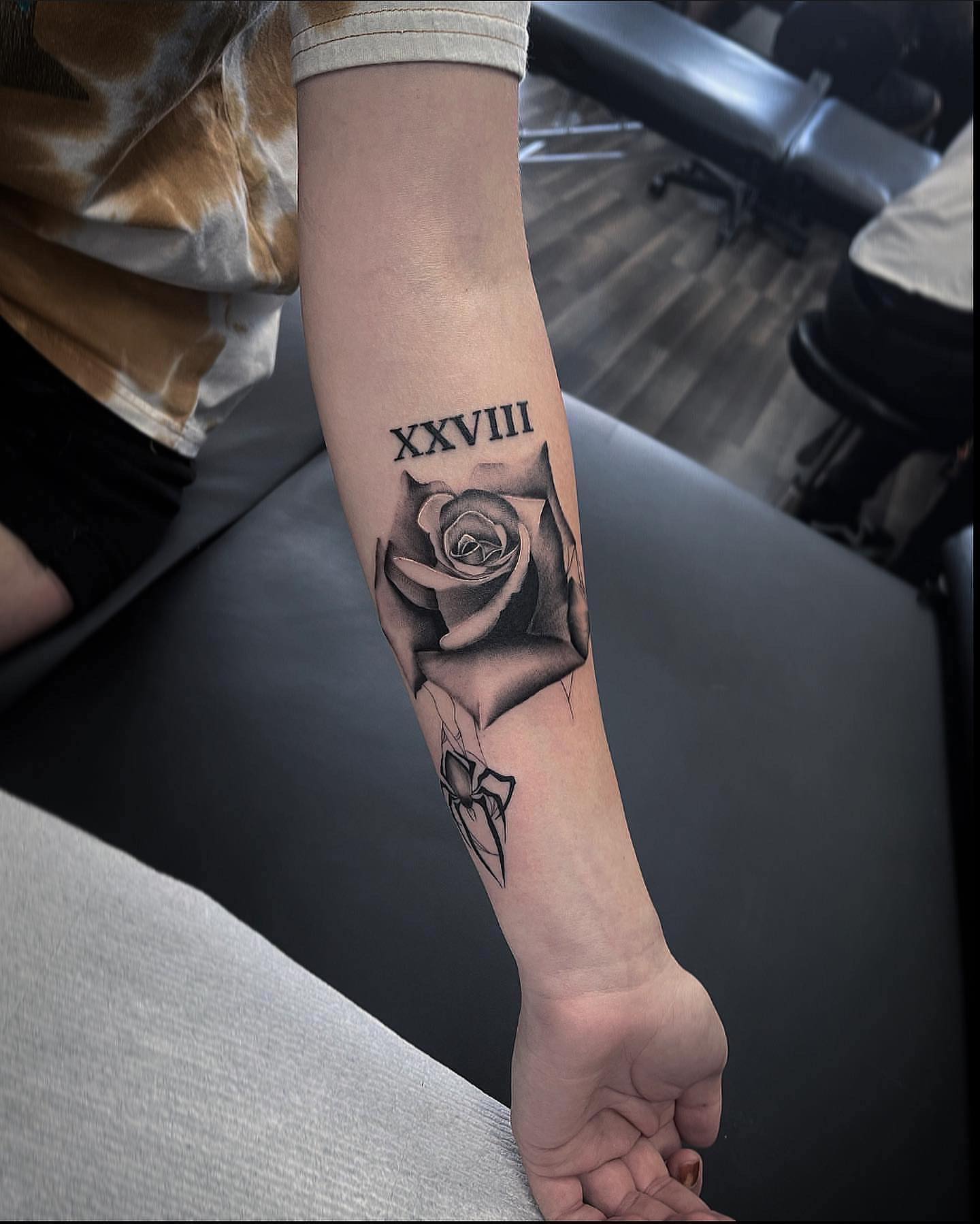 Rose and roman numerals black and grey tattoo on the forearm by Beans