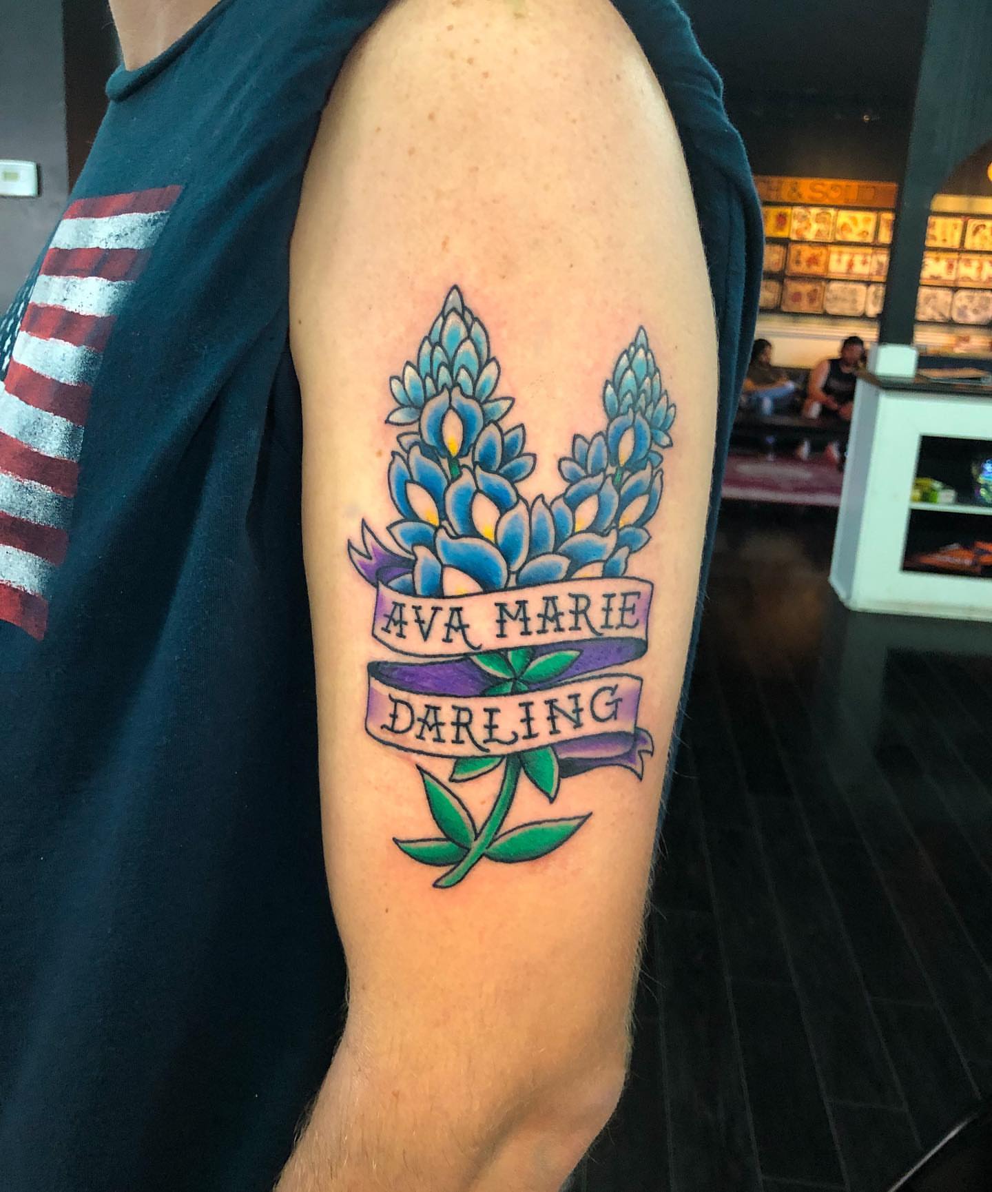 Bluebonnets and ribbon American traditional tattoo on the forearm by Tattoos by Rey G.