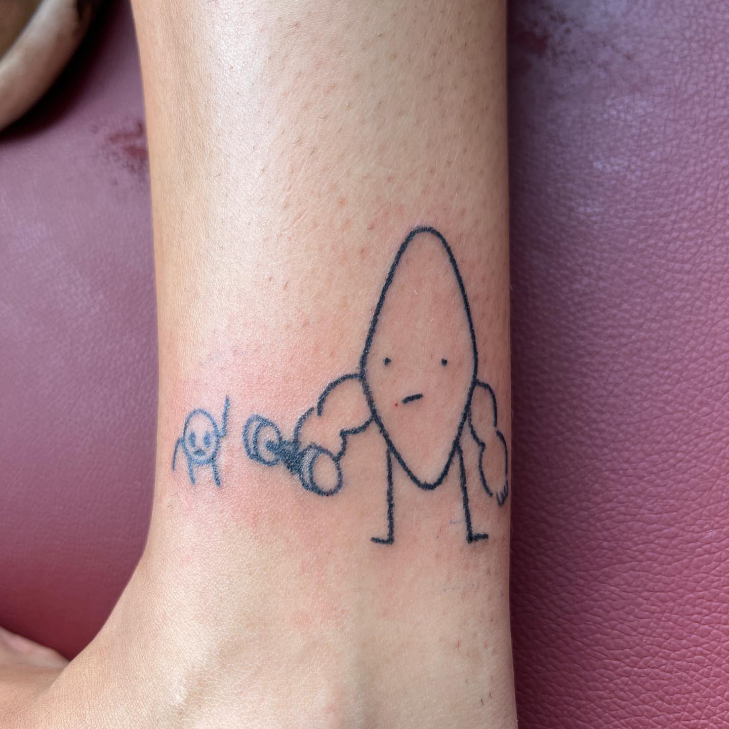 Rocket and alien minimalist tattoo on the forearm by mars