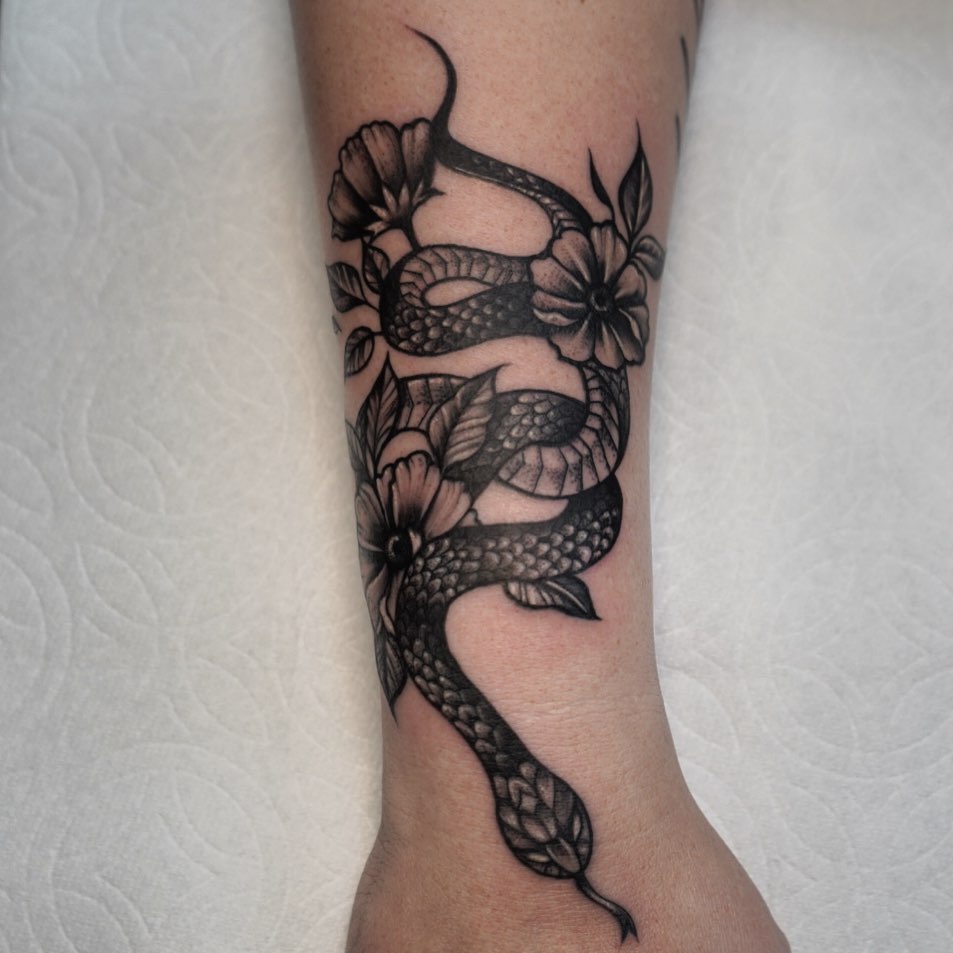 Snake and flowers realism tattoo on the forearm by Summer Rain