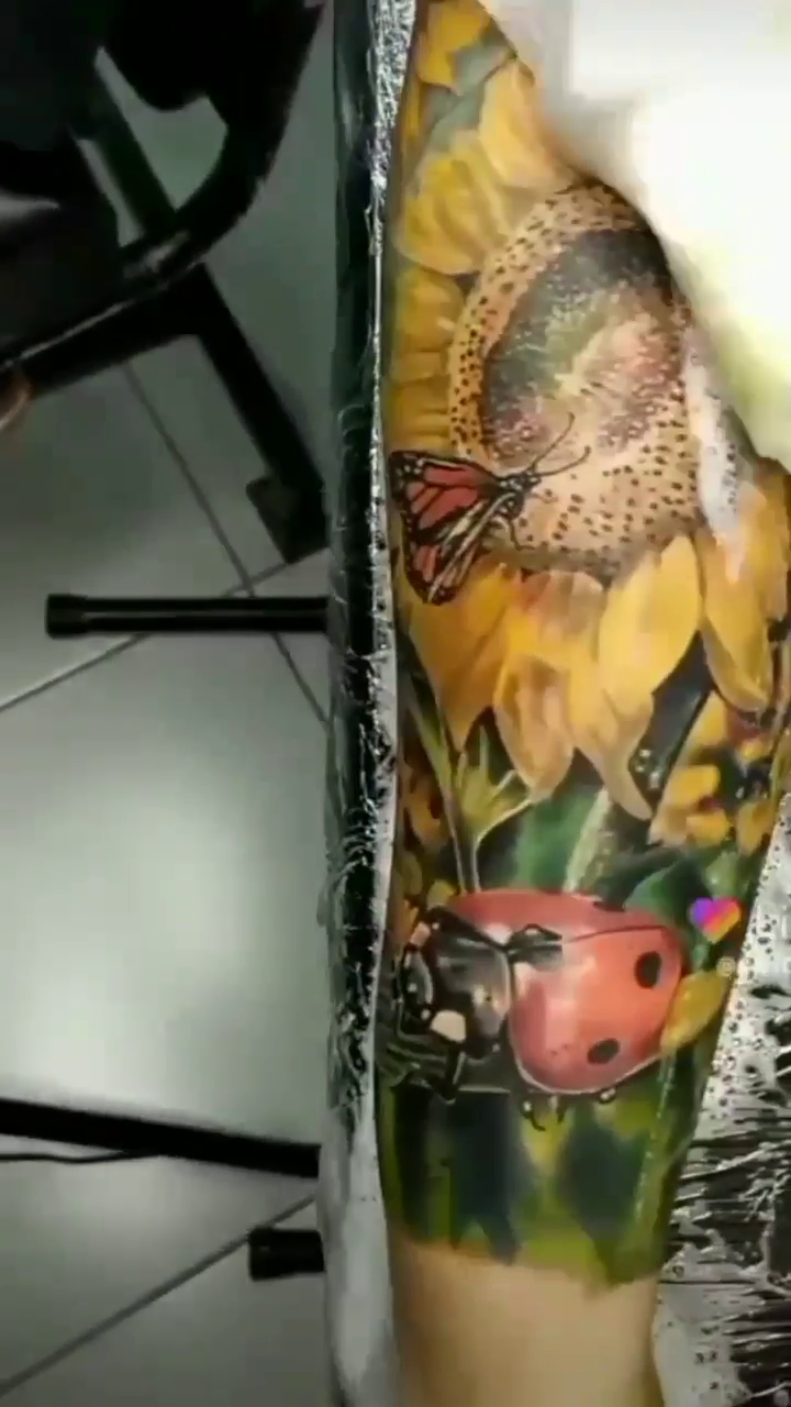 Sunflower with ladybug and butterfly realism tattoo by Guillermo Columbie, Houston, Texas