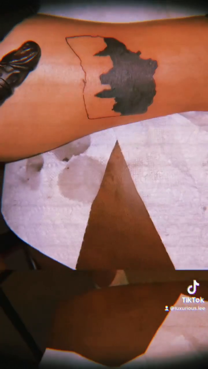 Outline of a map of Africa tattoo on the upper arm by ꧁༺𝓛𝓮𝓮༻꧂