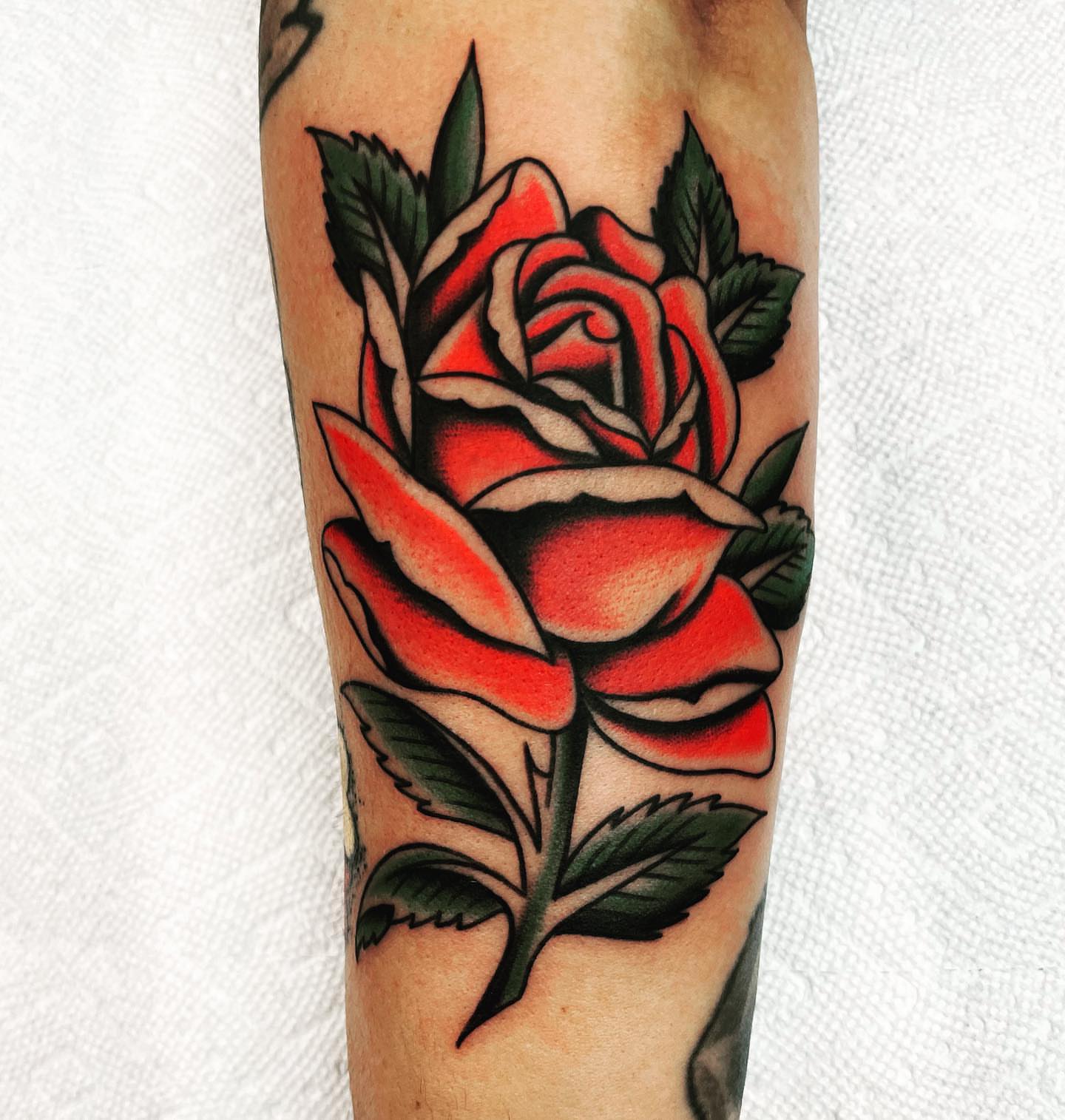 Red rose American traditional tattoo on the forearm by Dave G