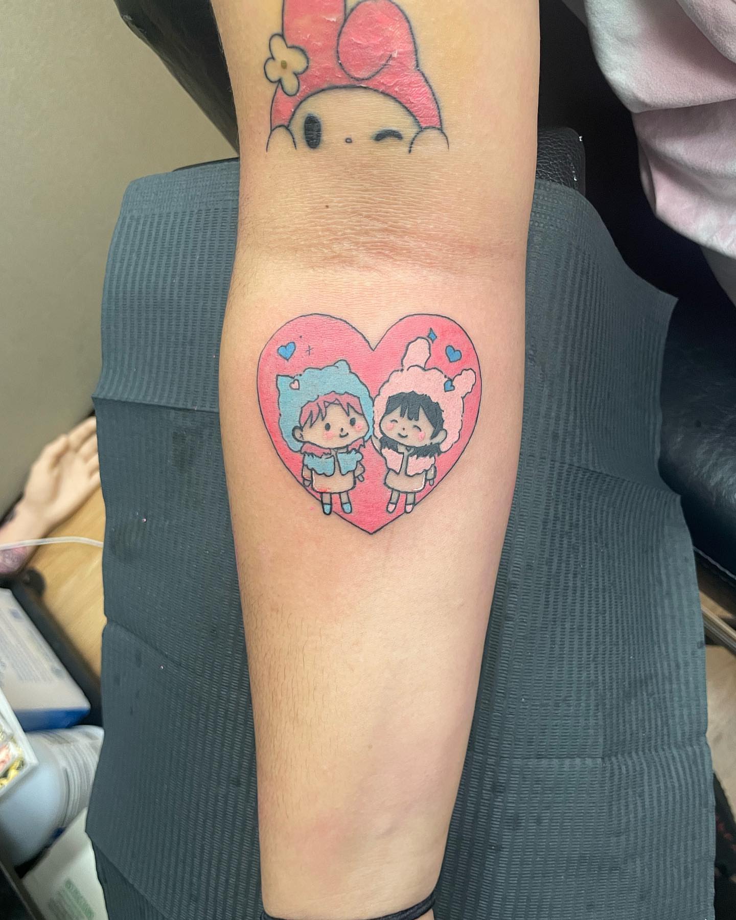Heart with two characters dotwork tattoo on the forearm by Cameron 🩸👻