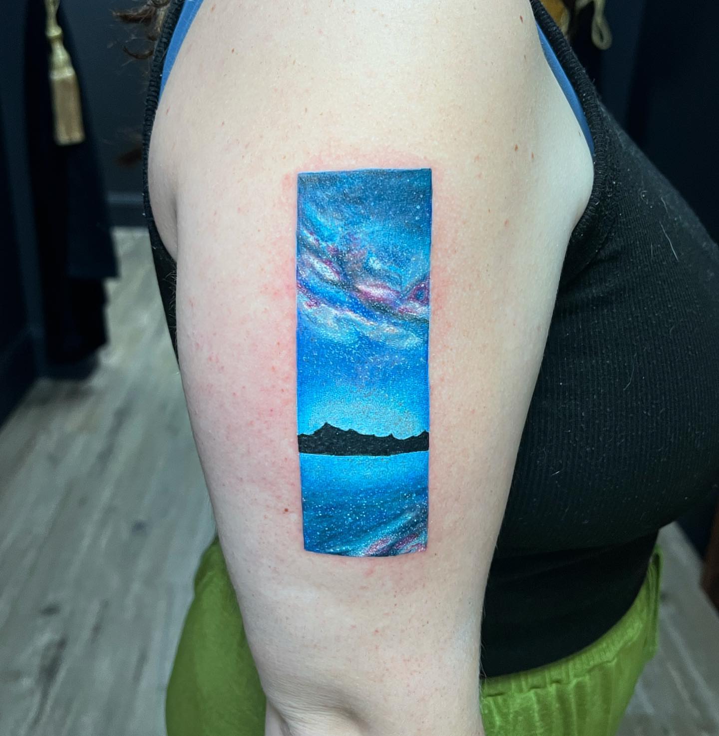 Galaxy landscape dotwork tattoo on the upper arm by Felipe Andrade