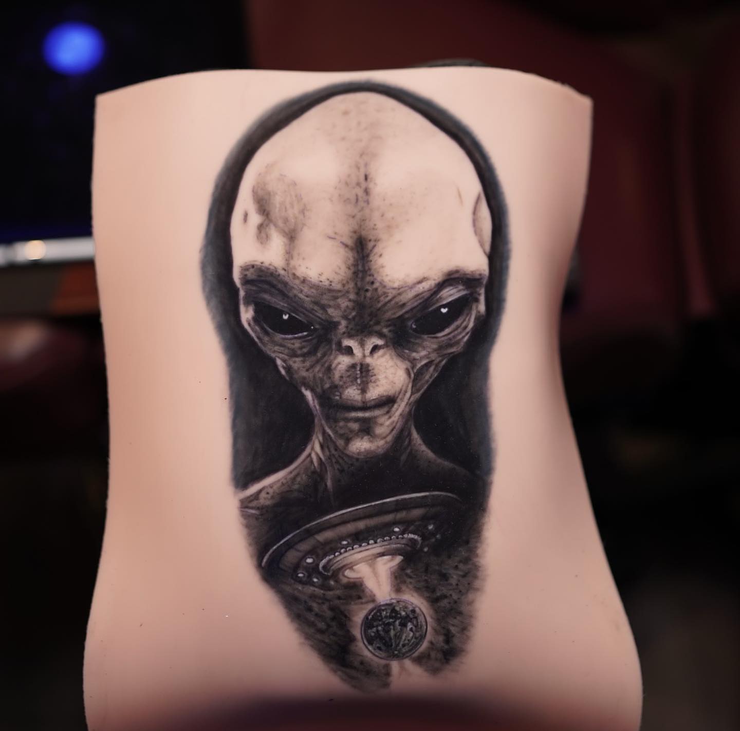 Alien realism tattoo on the forearm by Devin Mullen