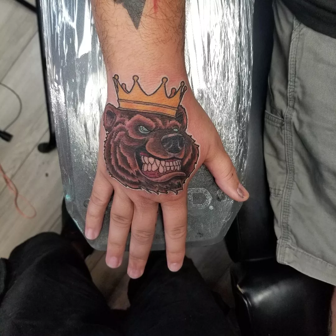Bear with crown realism tattoo on the hand by Chris TL Jones