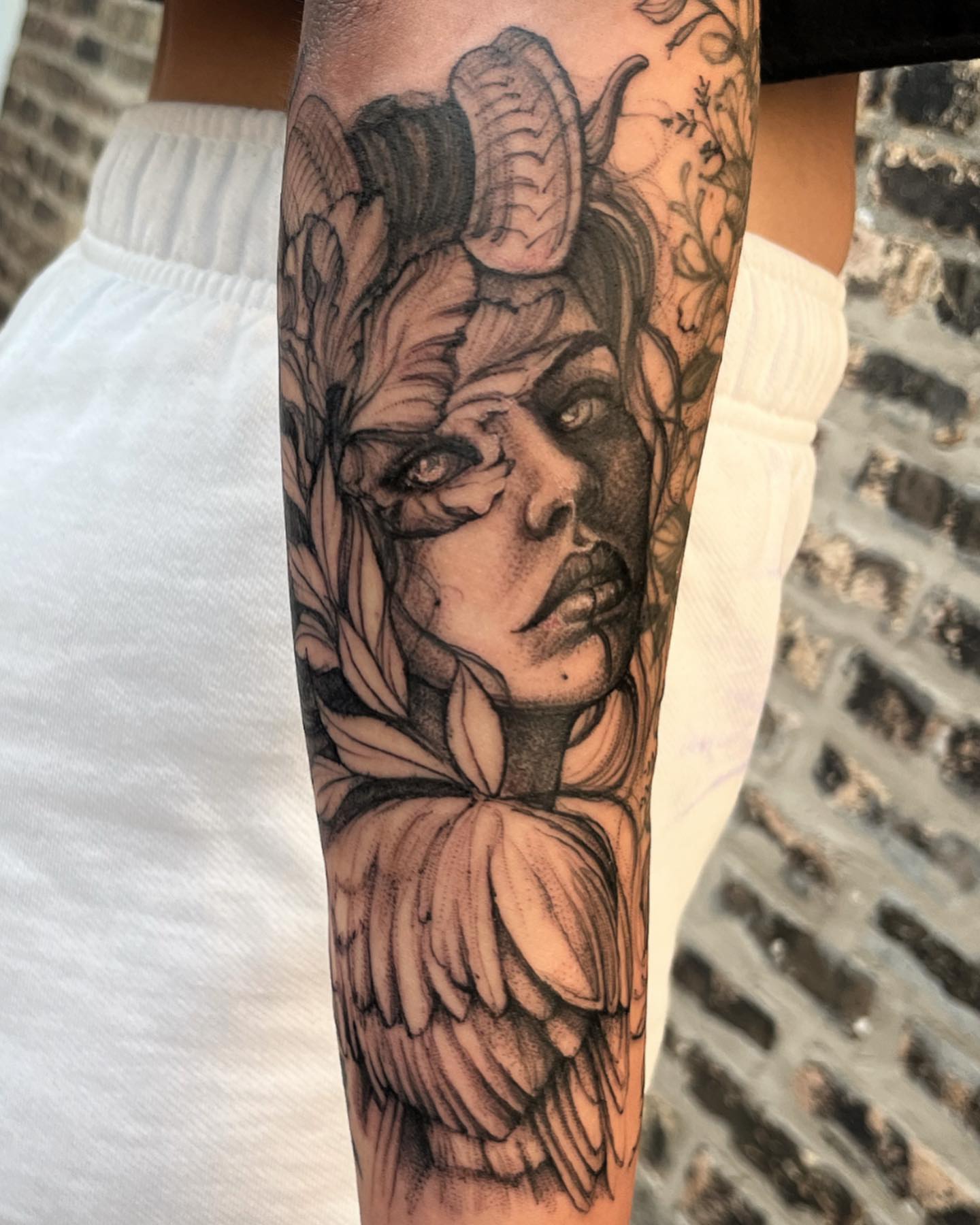 Woman with wings realism tattoo on the forearm by Sarah Spread
