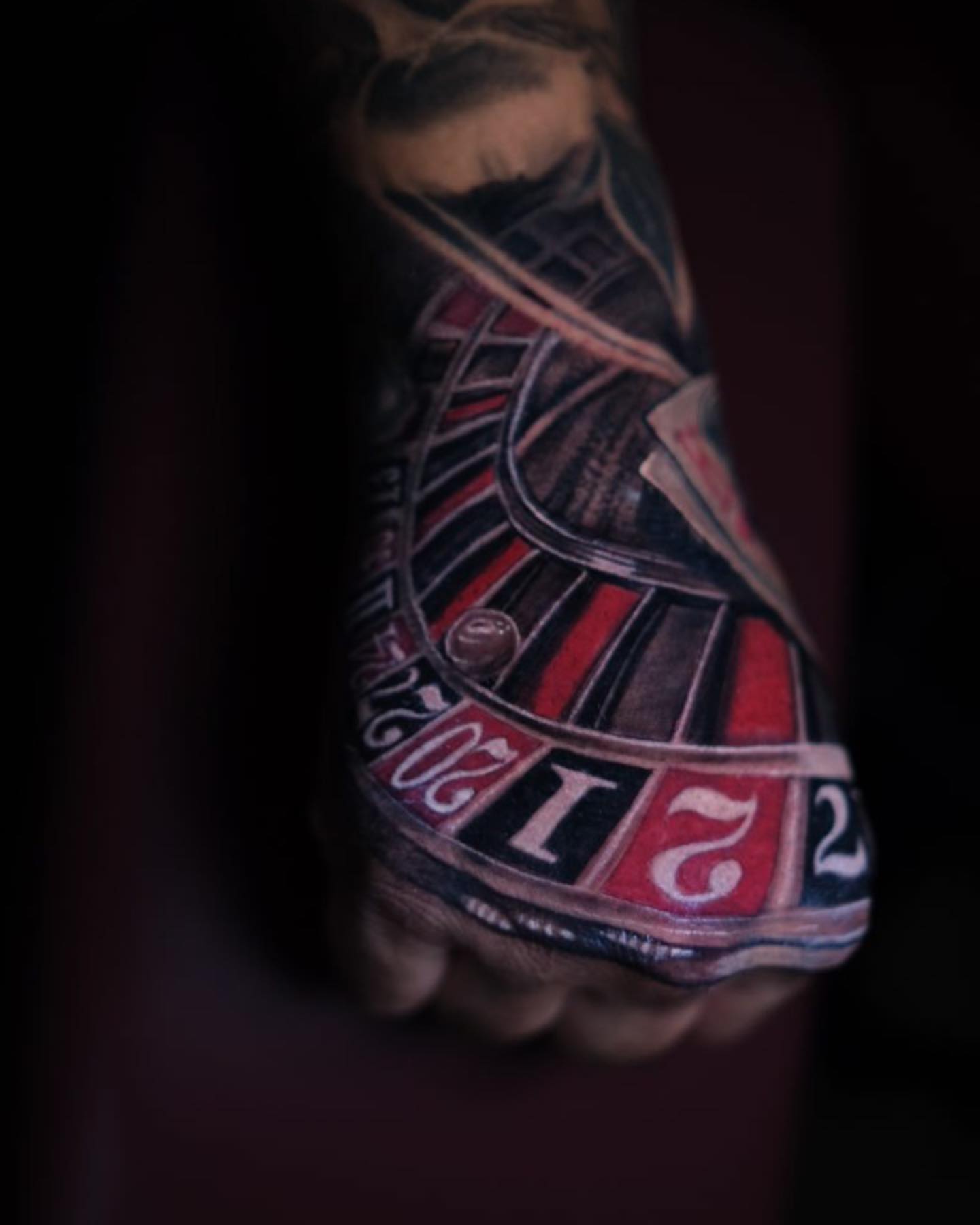 Roulette wheel realism tattoo on the hand by Christian Medina, Sacramento, California