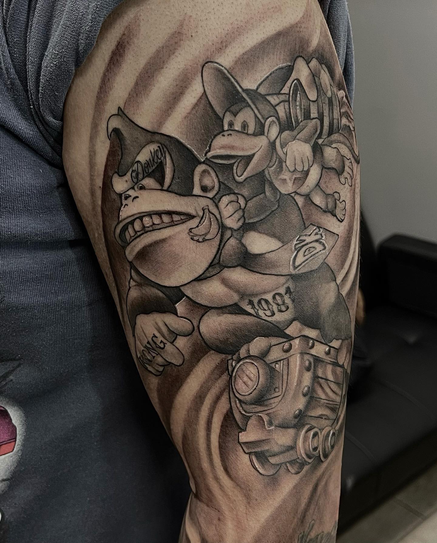 Donkey Kong and Diddy Kong realism tattoo on the forearm by Aaron Watson