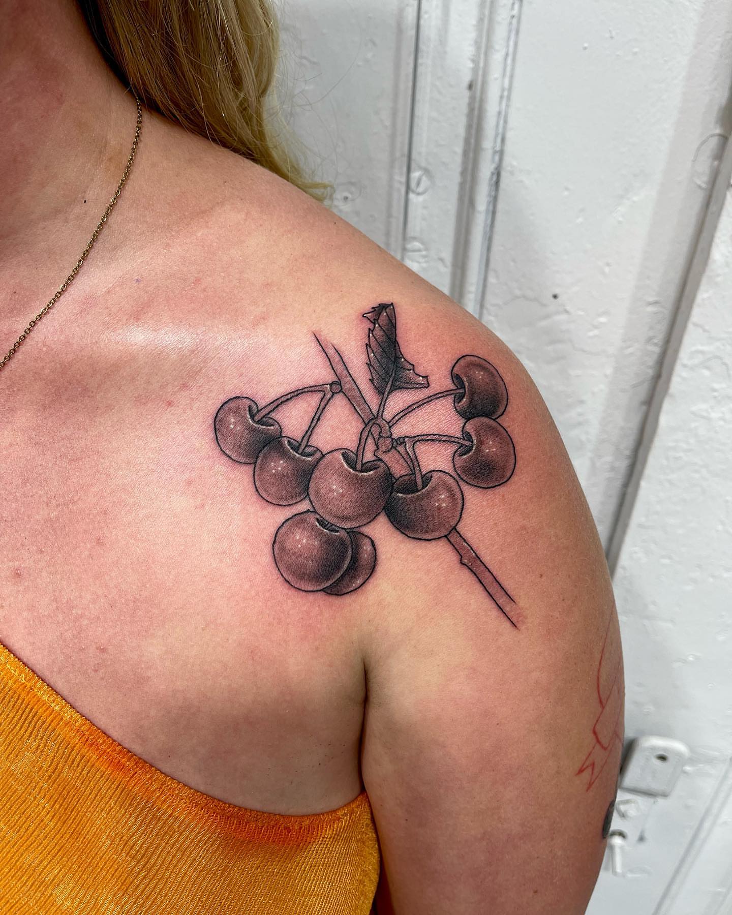 Cherries realism tattoo on the shoulder by Joce ☾, New York, New York