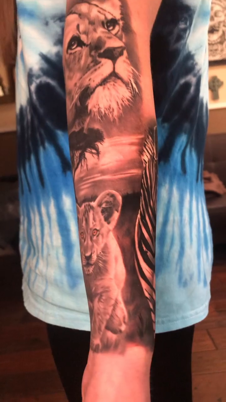 Lion family in savanna realism tattoo by Michael Martinez